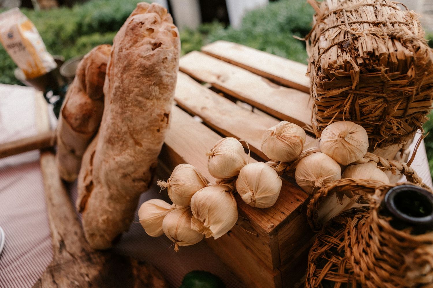 Close-up photo of raw ginger root showing its knobby texture and brown skin on a wooden surface.