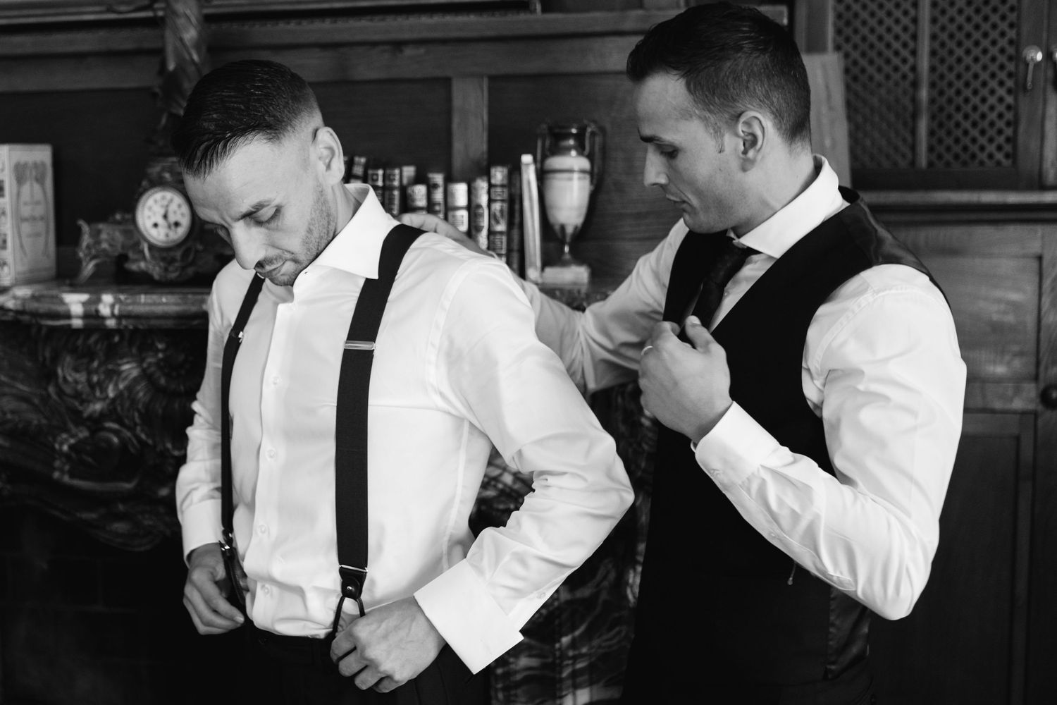 A black and white photo sequence showing someone lighting and smoking a cigarette in formal attire.