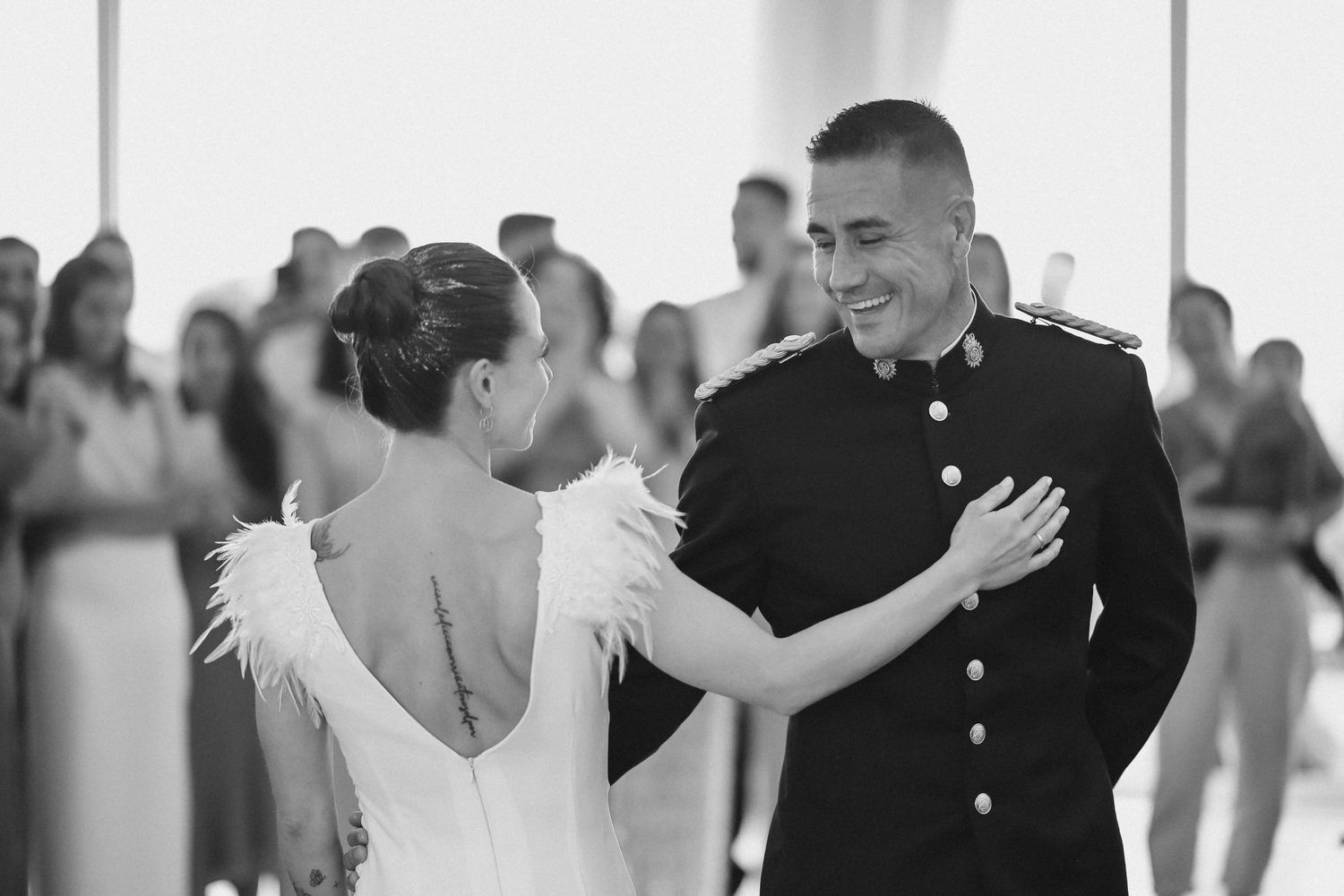 Wedding guests dance and celebrate together on a bright dance floor at a joyful reception celebration.