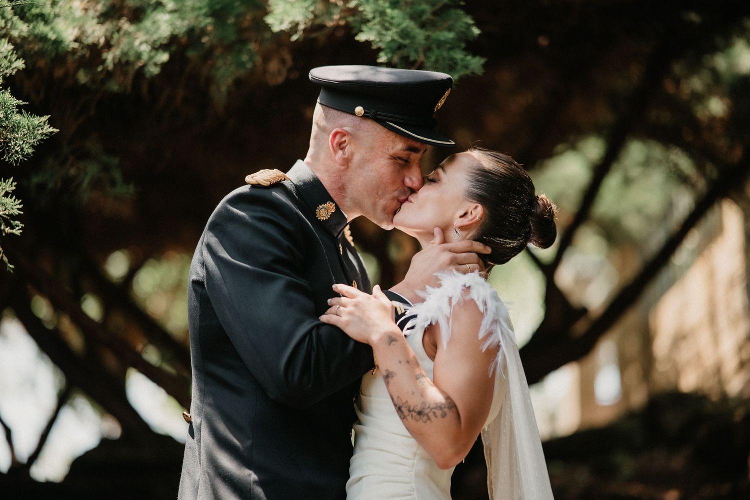 A romantic wedding couple shares intimate kisses in a series of outdoor portraits under natural lighting.