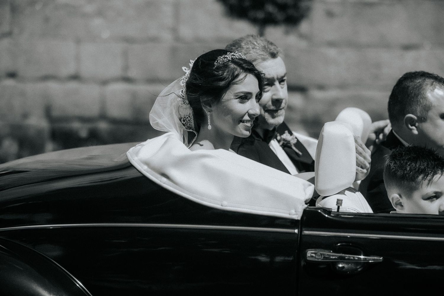 Guests at a wedding ceremony embrace and congratulate each other in a heartfelt moment.