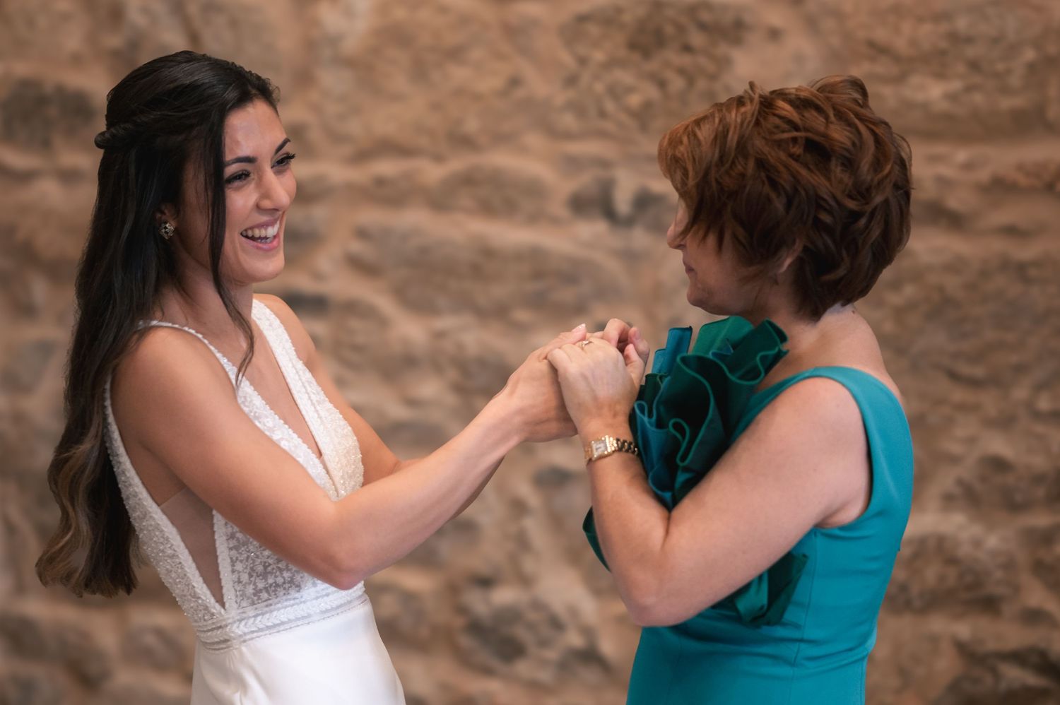 People in formal wear embracing and sharing emotional moments during a special occasion.