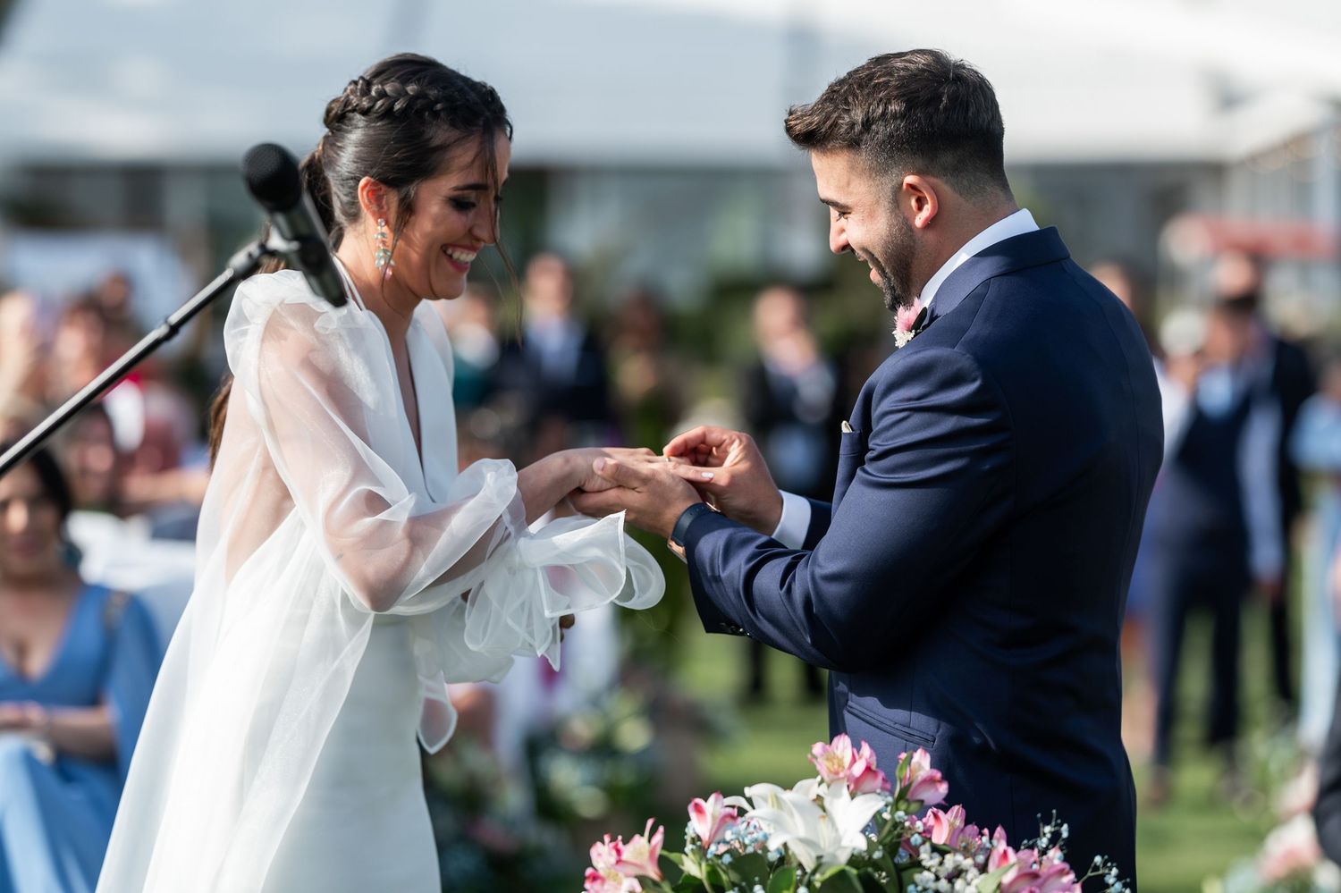 Wedding couple shares a special moment during their outdoor celebration with floral arrangements.