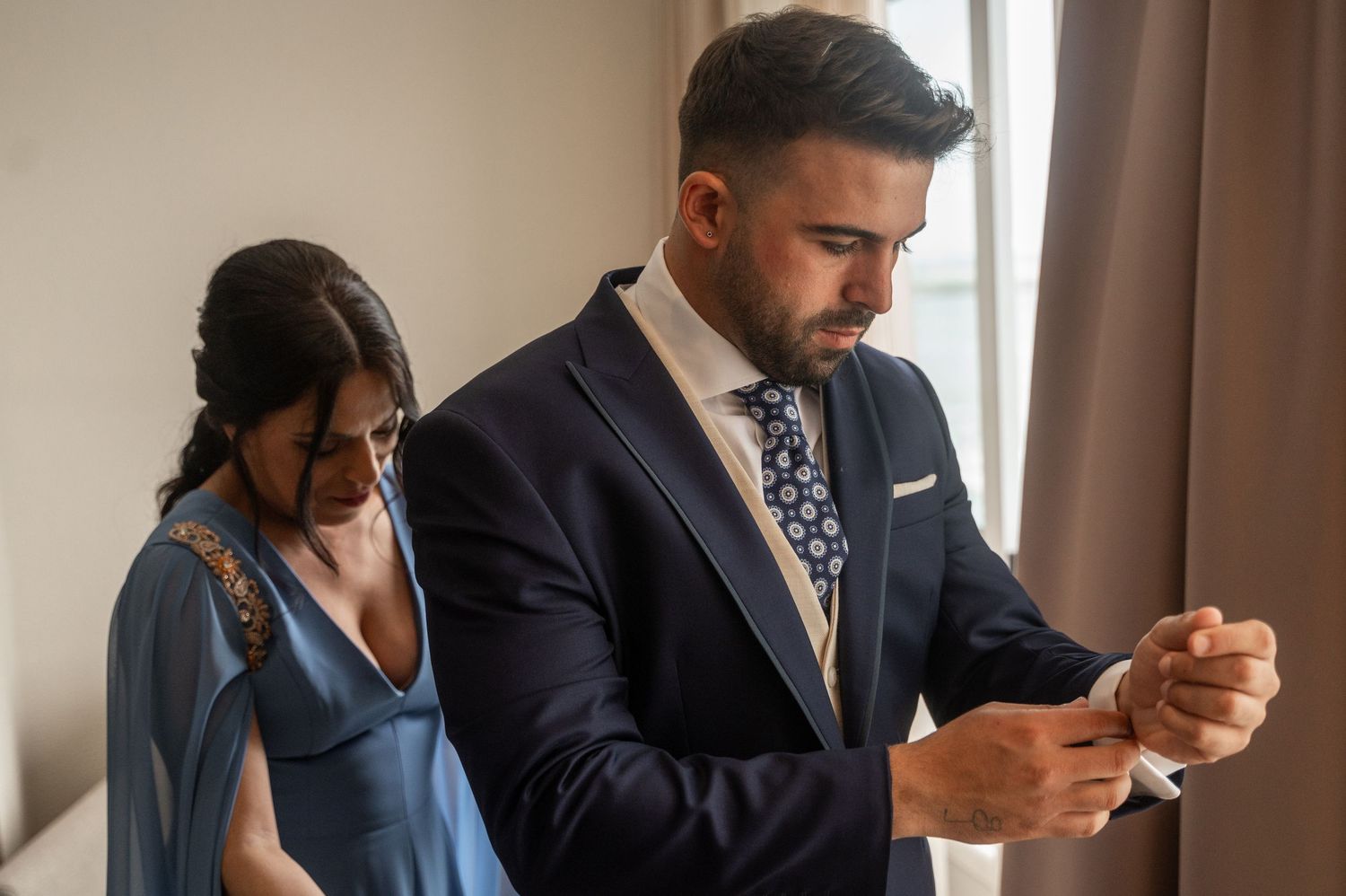 Business professionals checking their mobile phones while waiting in an office hallway.