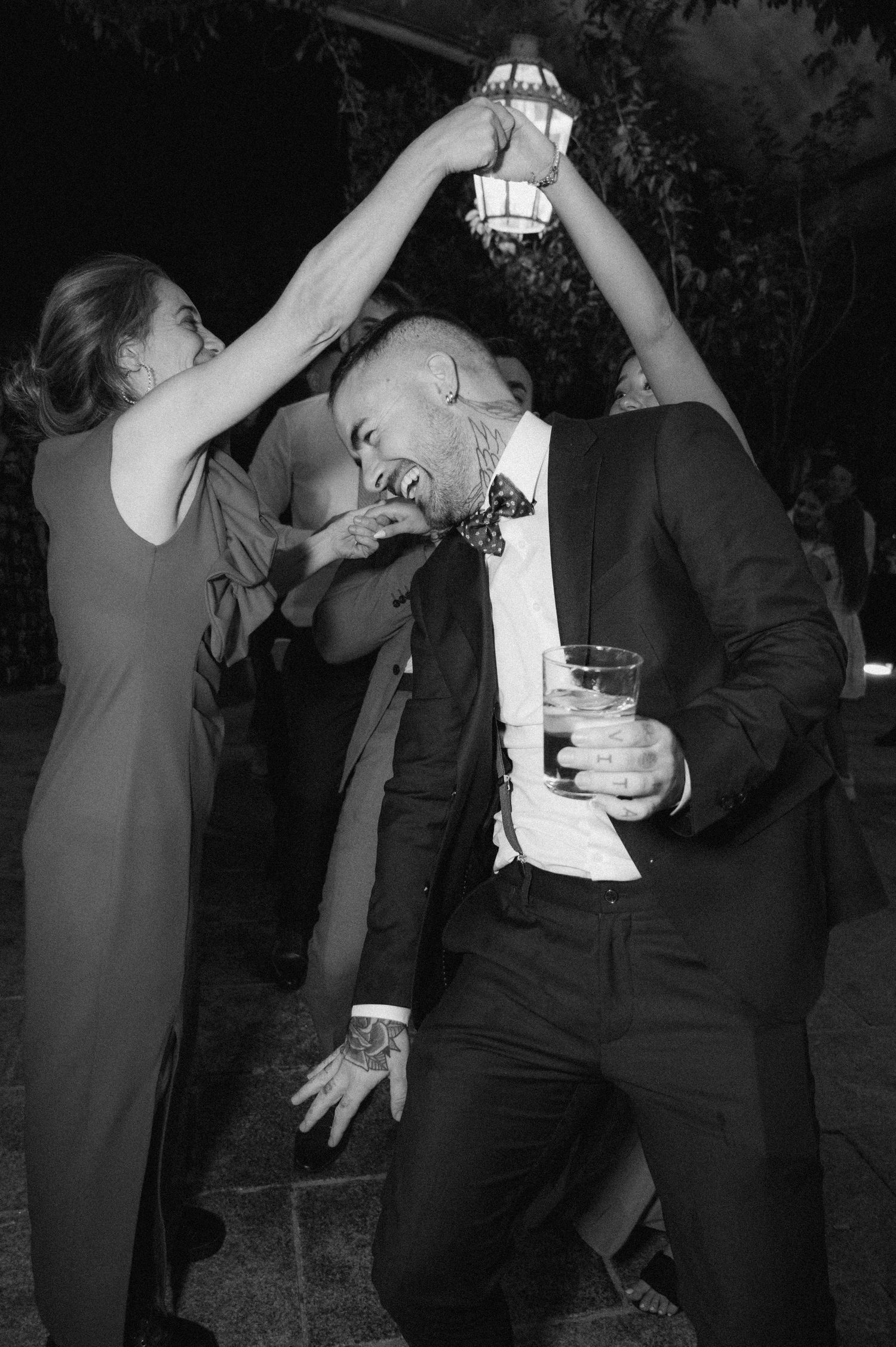 Black and white photos showing a sequence of people dancing and celebrating at a party.