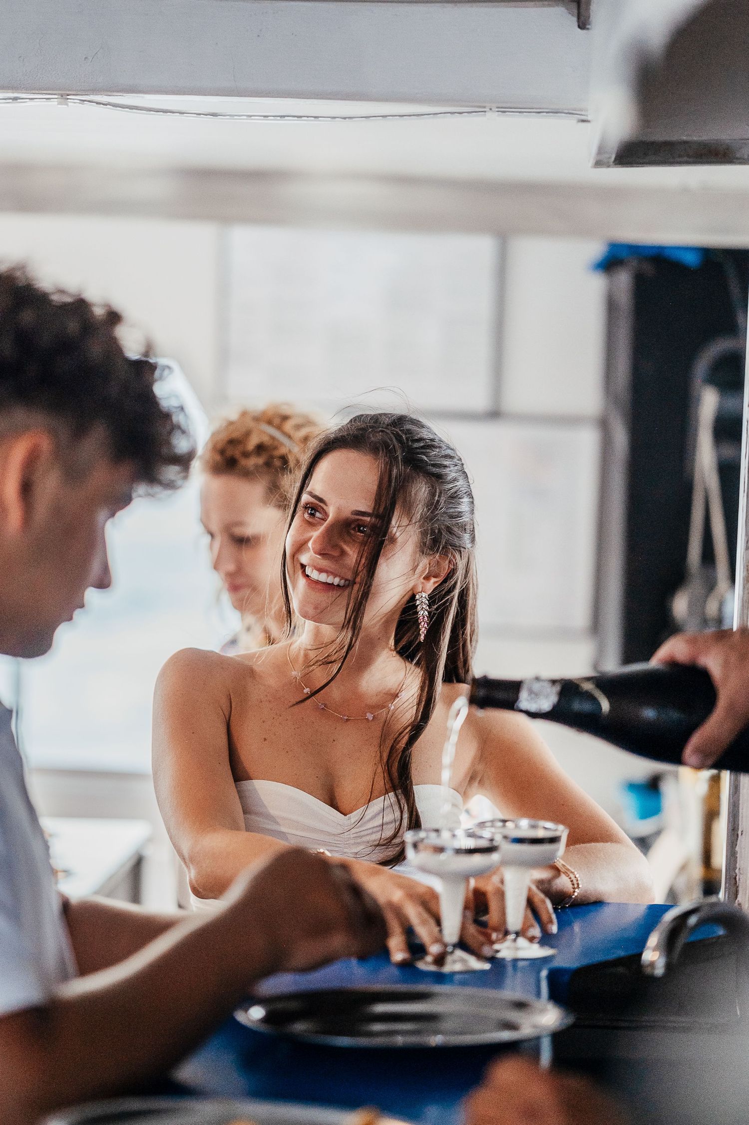 Friends enjoying conversation and drinks at a casual gathering around a table.