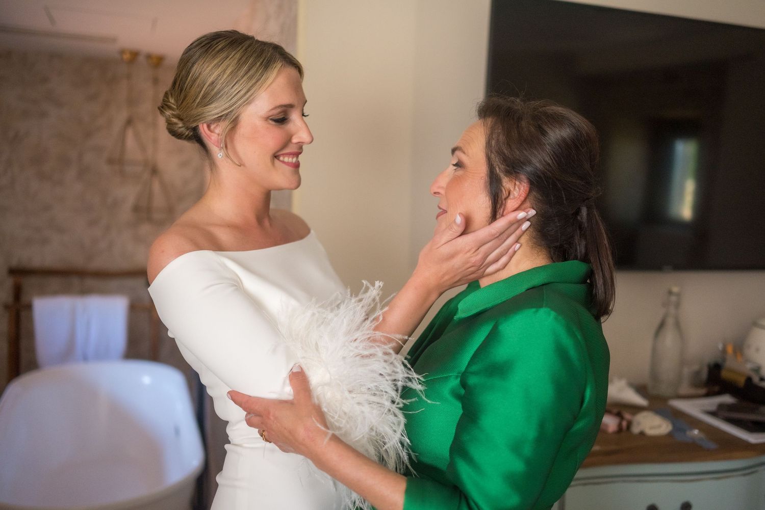 A touching moment between two people at a wedding celebration.