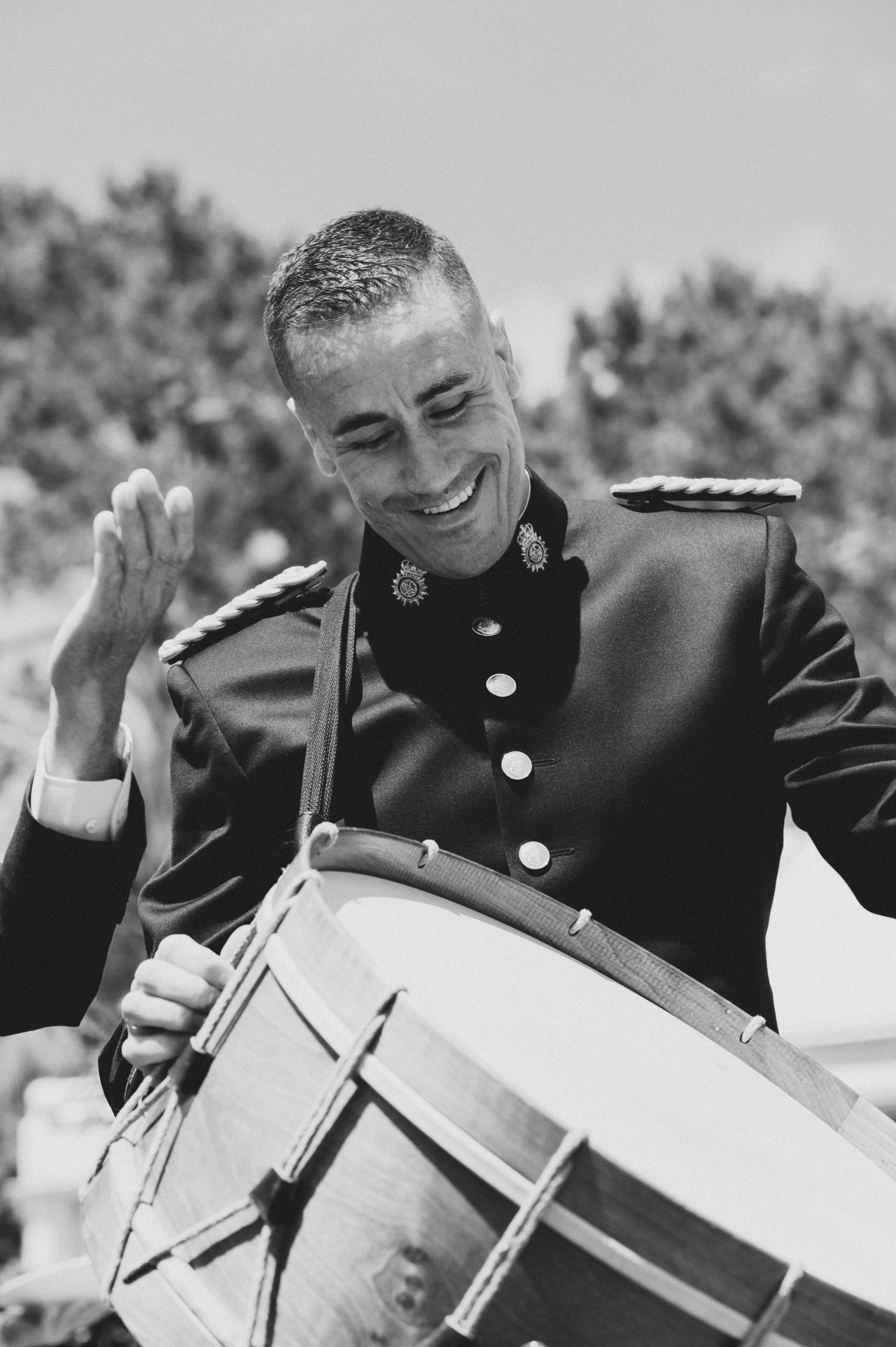 A series of black and white photos showing a drummer performing with animated expressions and gestures.