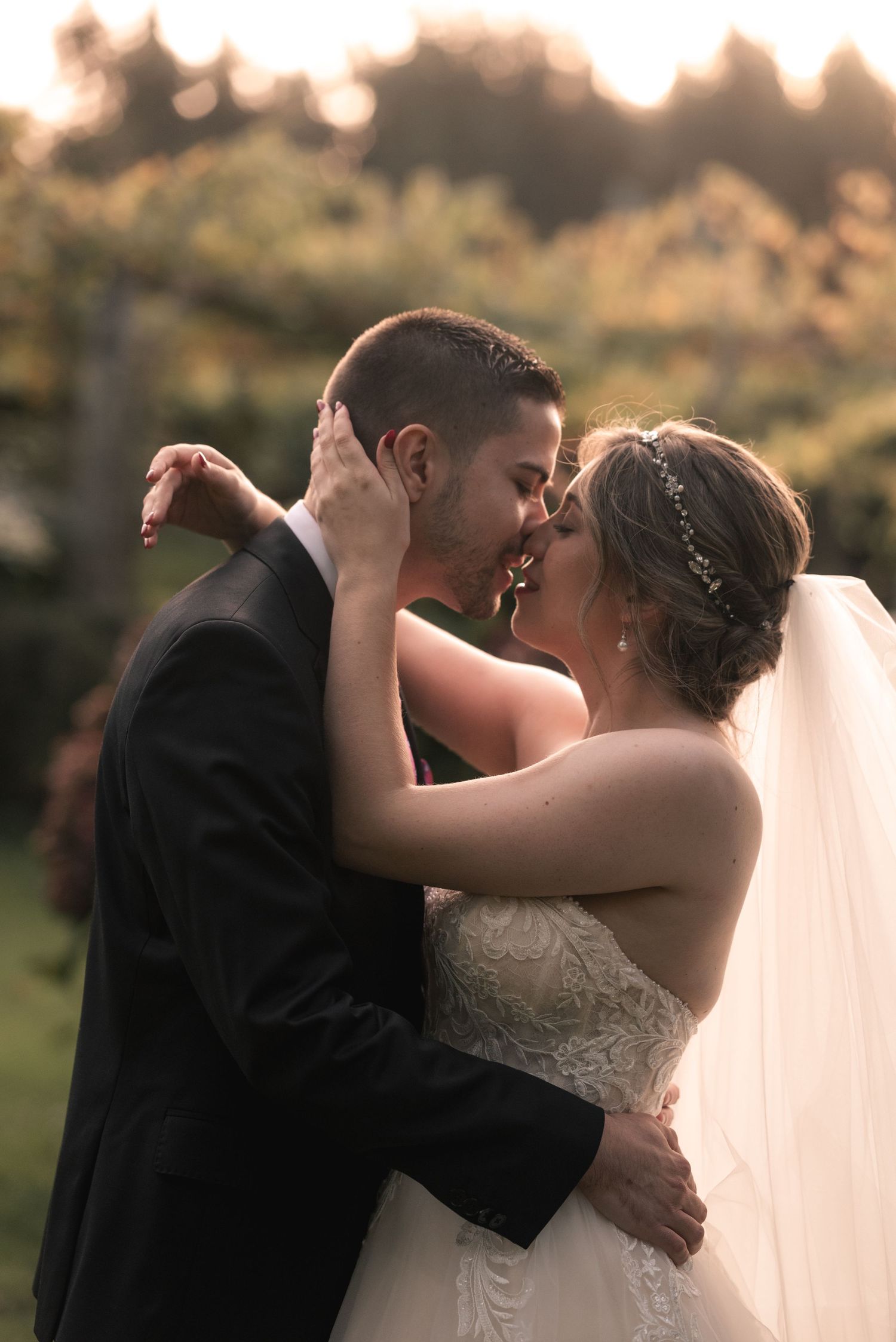 A romantic sequence of wedding photos shows a couple sharing their first kiss as newlyweds during golden hour.