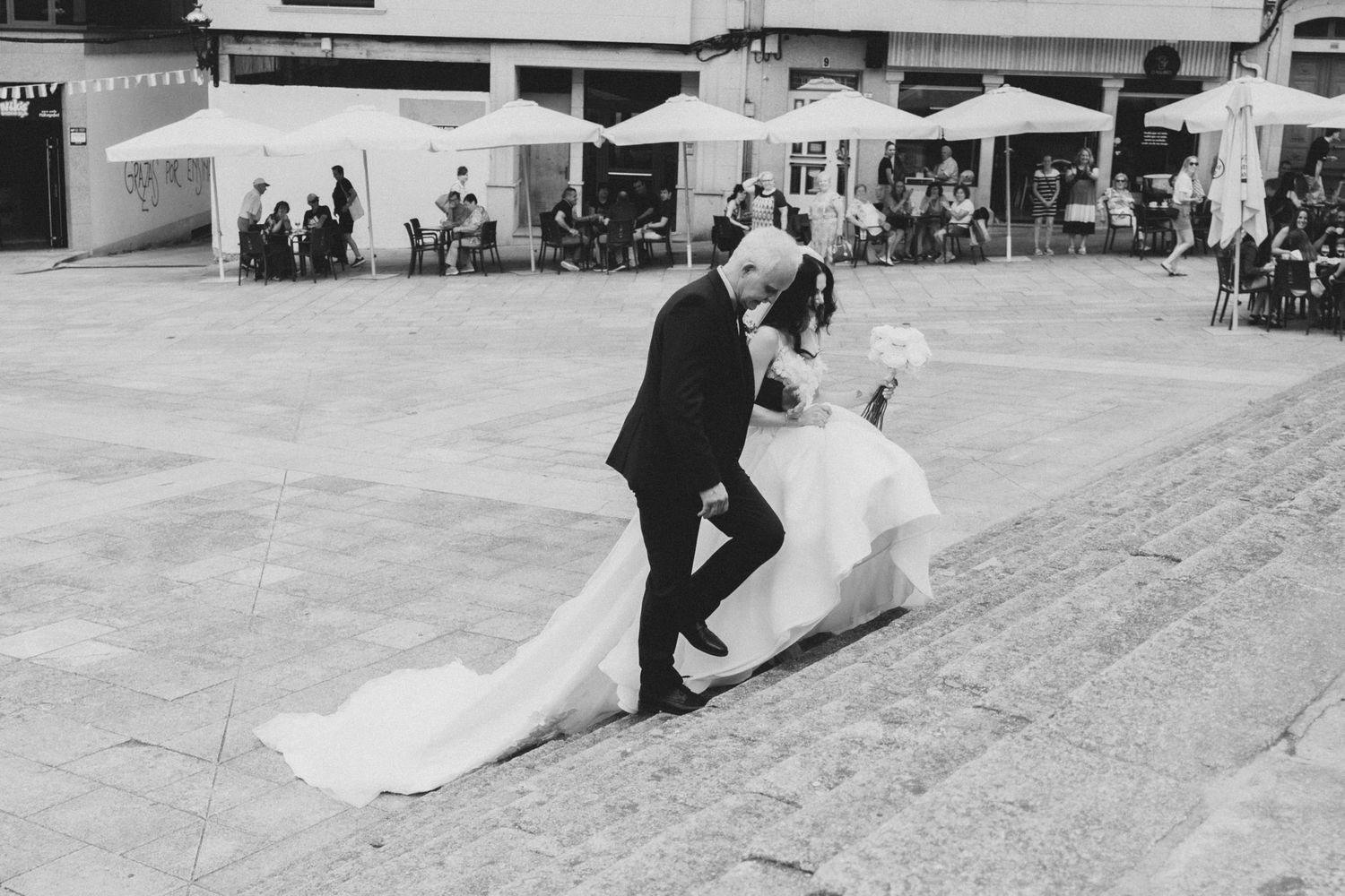 A sequence of black and white photos showing a couple dancing at their wedding reception on a dance floor.