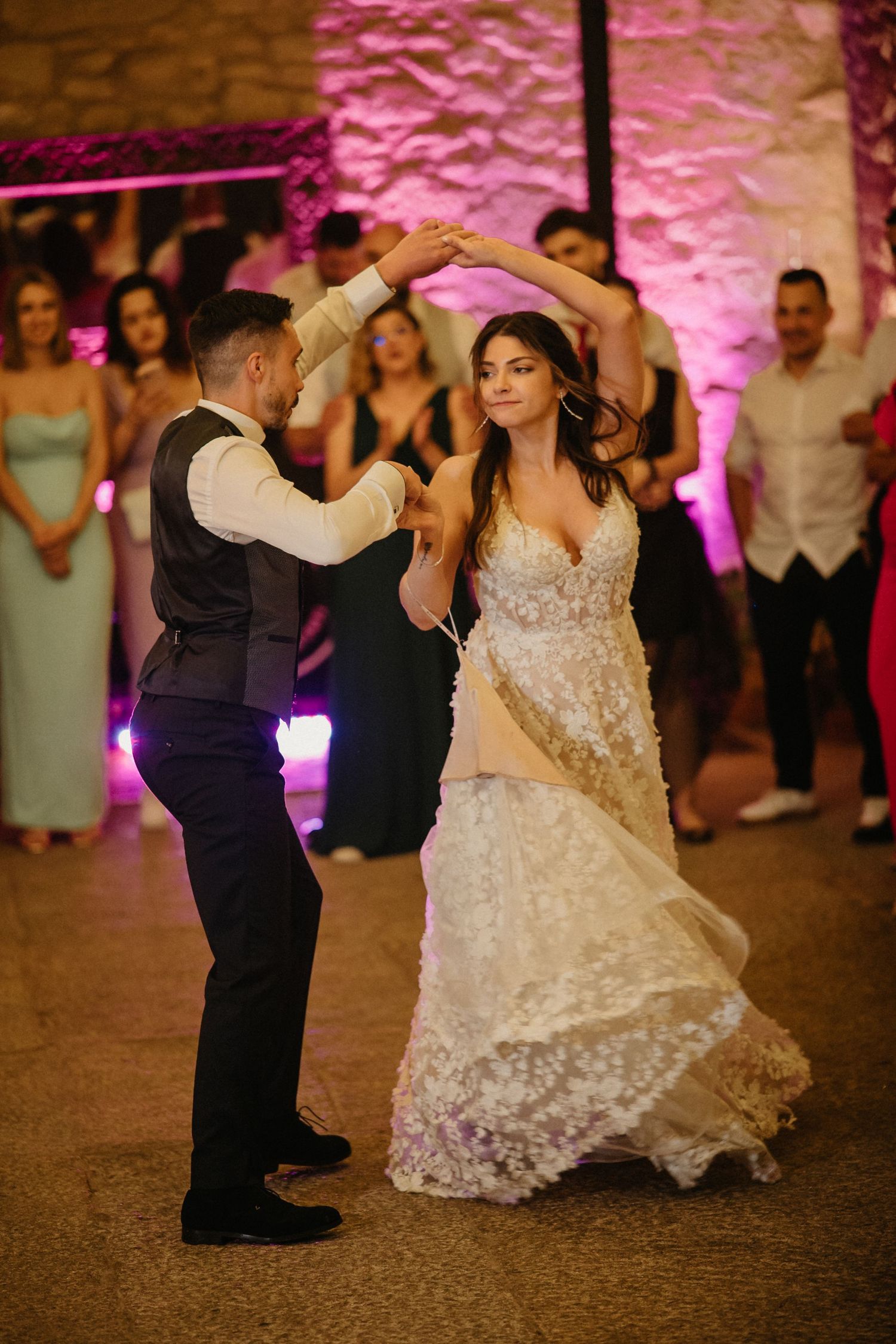 A sequence of dance moves captured during a wedding reception with a bride in a white lace gown twirling on the dance floor.