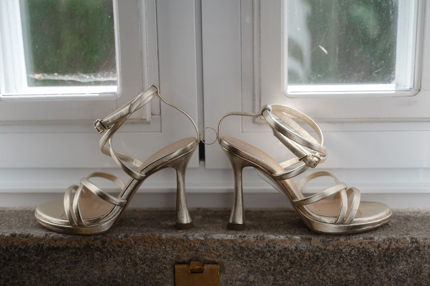 Elegant white strappy high heel wedding shoes displayed in sequence against a light background.