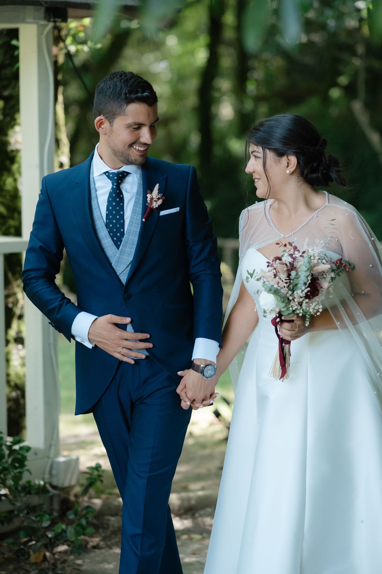 A series of romantic wedding photos showing a couple in navy suit and white dress posing playfully outdoors.