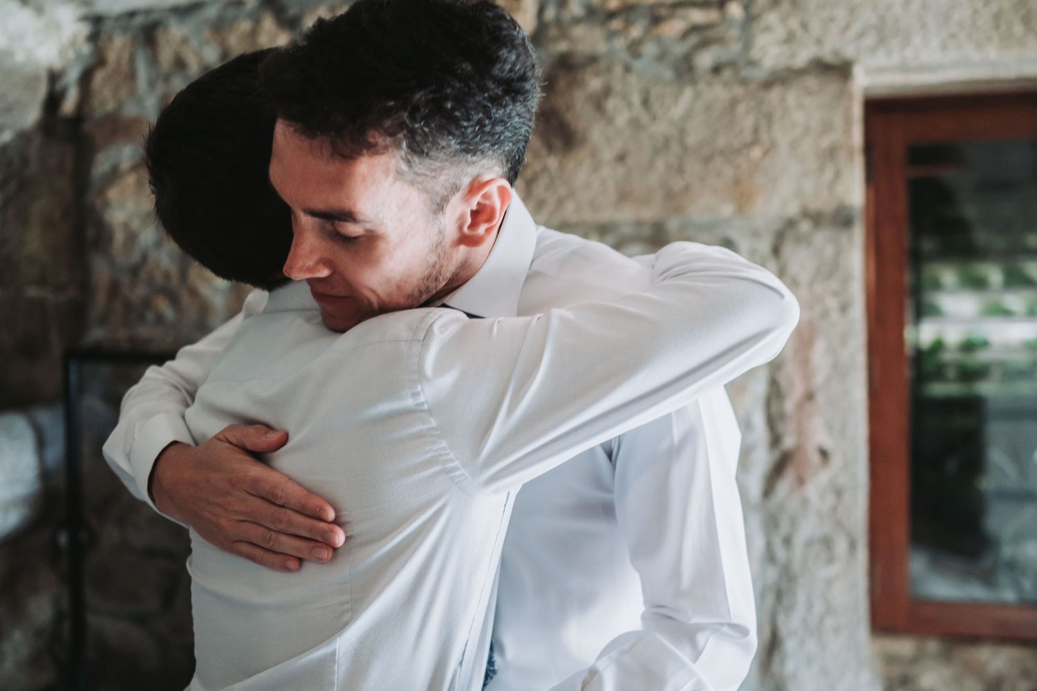 Close up shots of two people embracing in white formal attire.