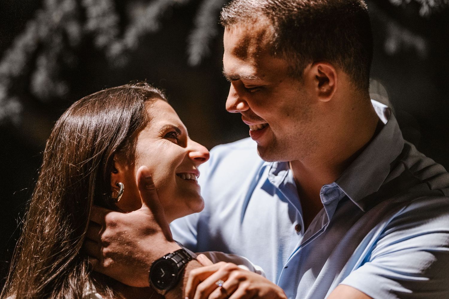 A romantic couple shares intimate moments in a series of black and white engagement photos.