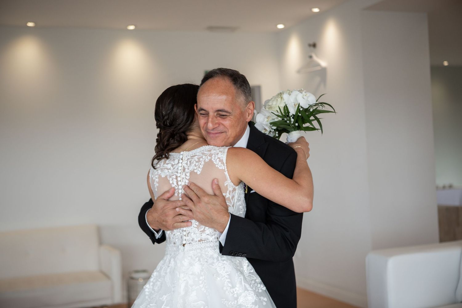 A sequence of wedding photos capturing intimate embraces and joyful moments in a bright indoor setting.