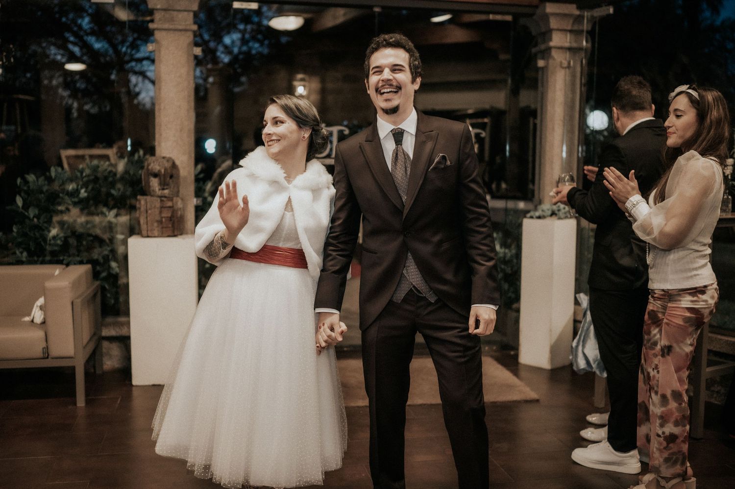 Wedding couple shares a joyful moment during their first dance in a beautifully decorated reception venue.