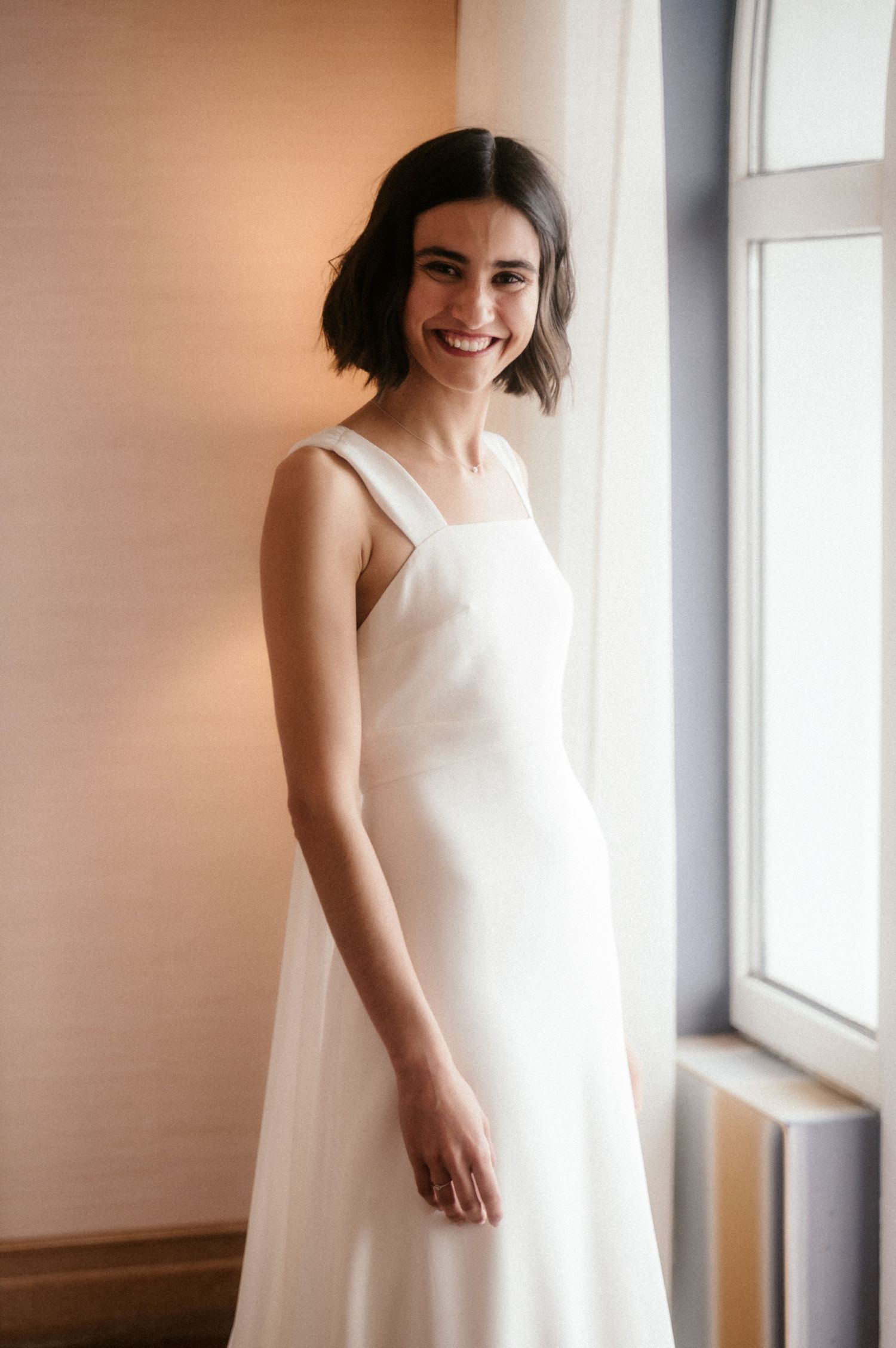 A series of soft, dreamy portraits showing someone in a flowing white dress near a window with natural light.