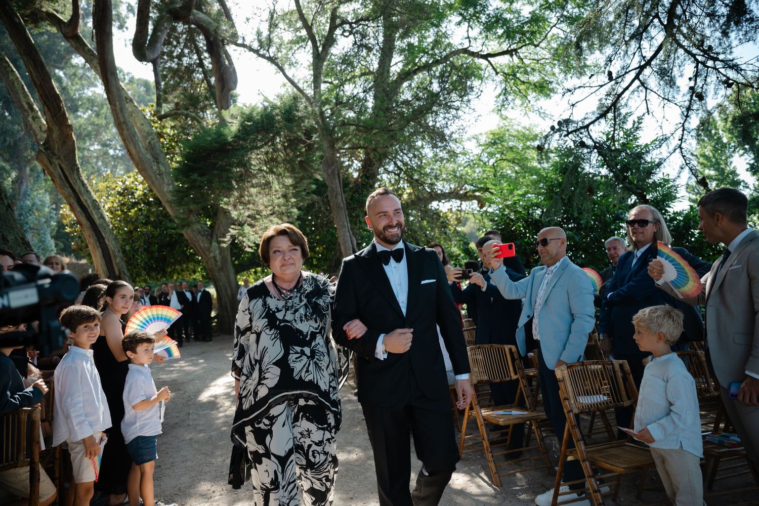 A sequence of outdoor wedding ceremony moments showing guests gathering under trees in a natural garden setting.
