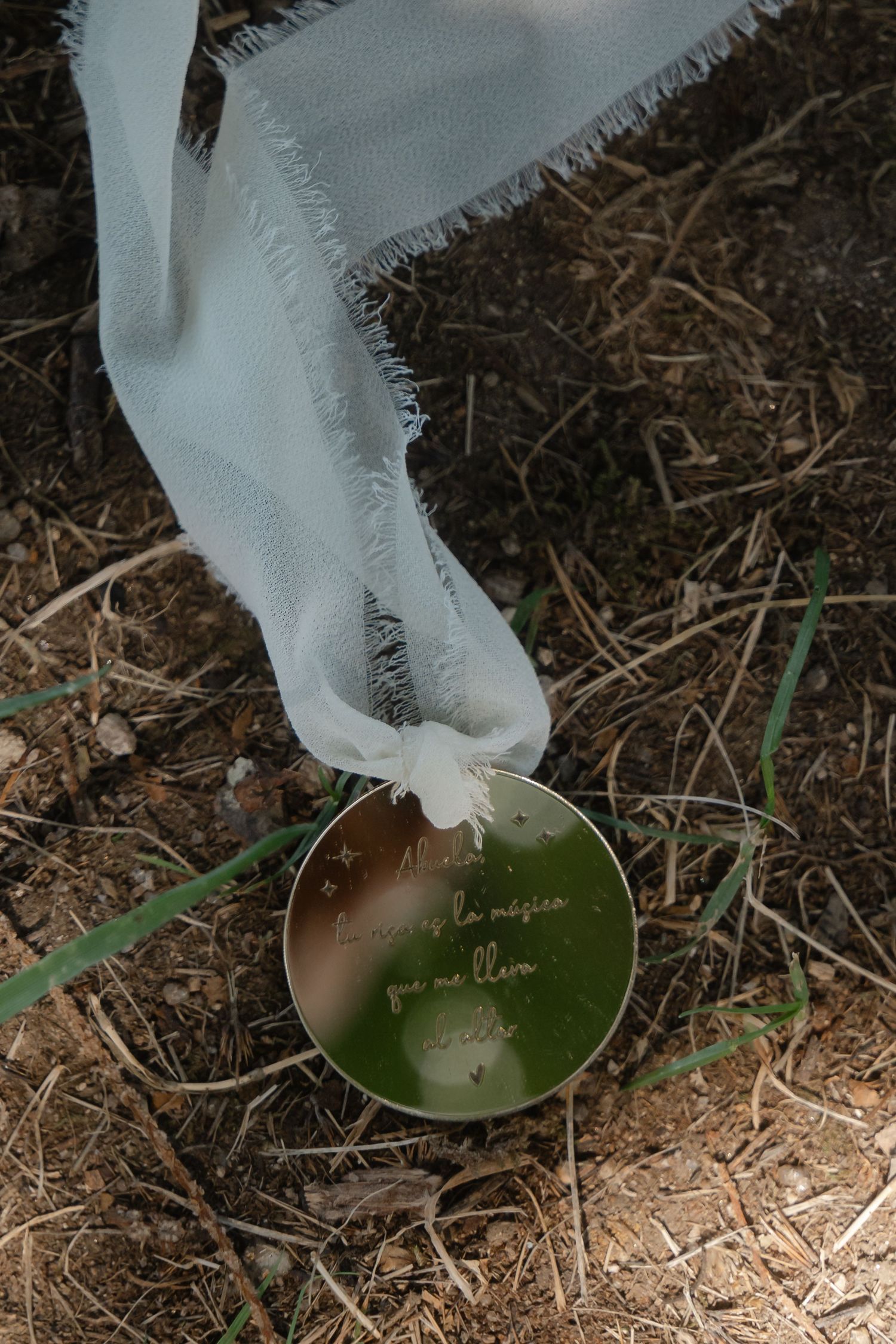 Close-up sequence showing a white wedding dress hem trailing over natural ground and grass.