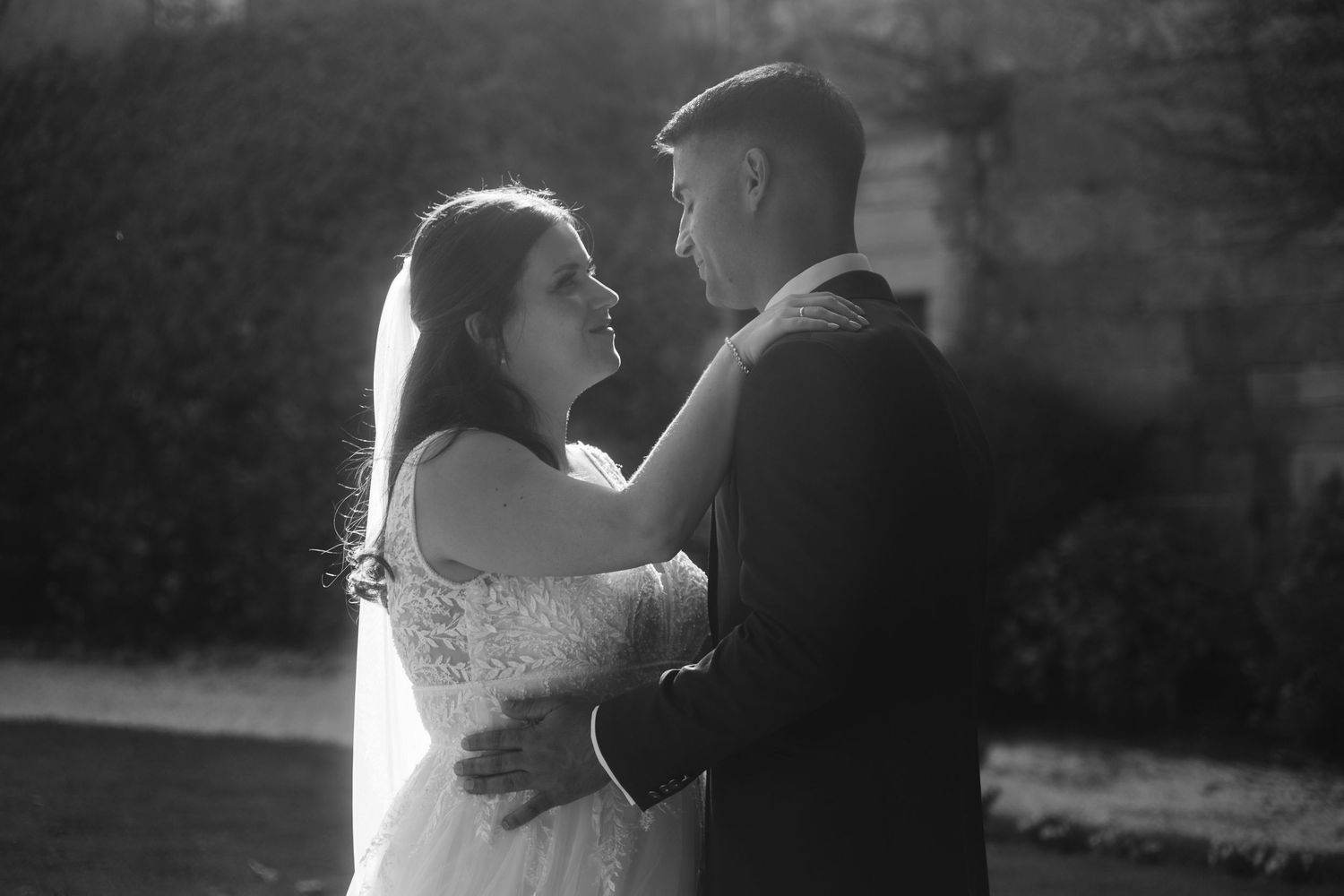 Artistic black and white wedding portraits showing silhouettes and emotional moments outdoors.