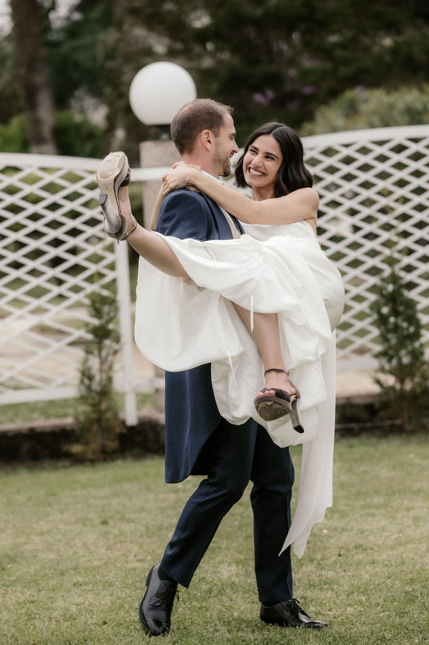 Playful wedding photo sequence showing the bride lifting her dress to show boots while dancing with groom.