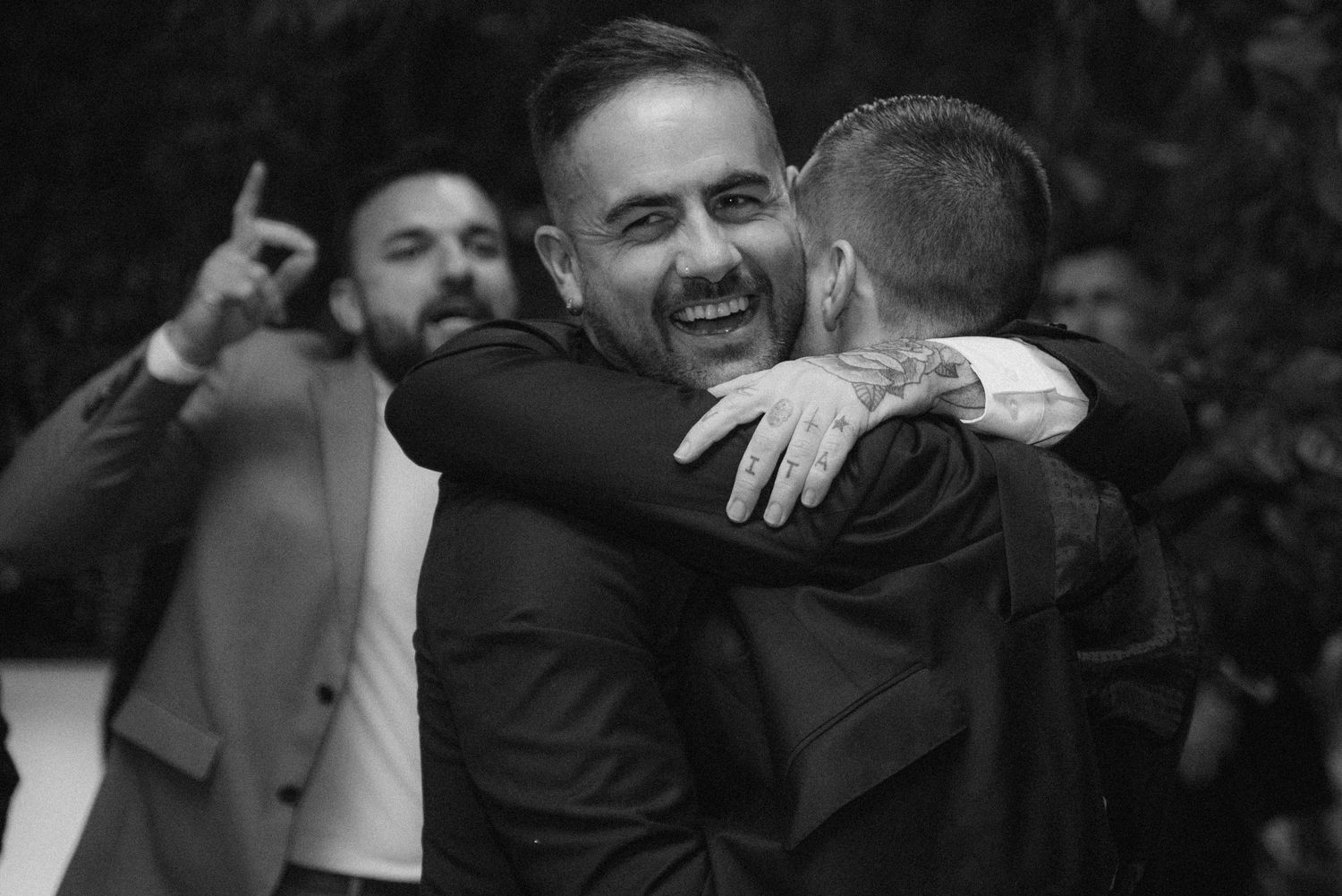 Group of people celebrating and hugging at what appears to be a sporting event or celebration.