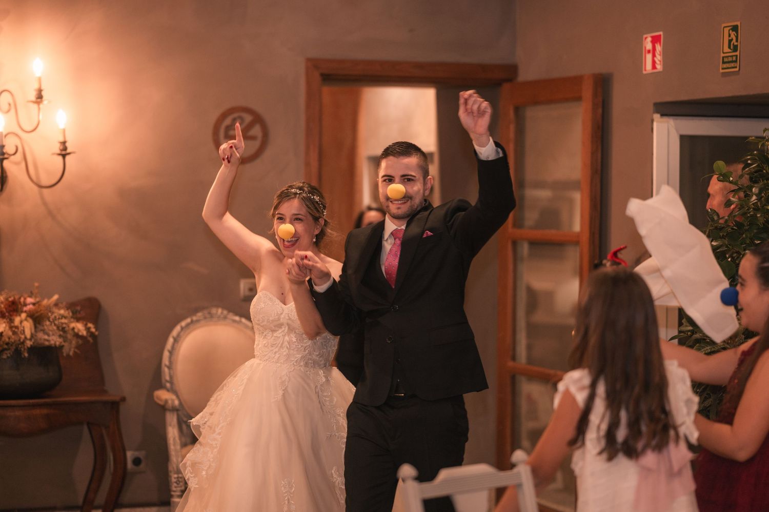 Wedding couple dances together during their first dance at a rustic indoor reception venue.