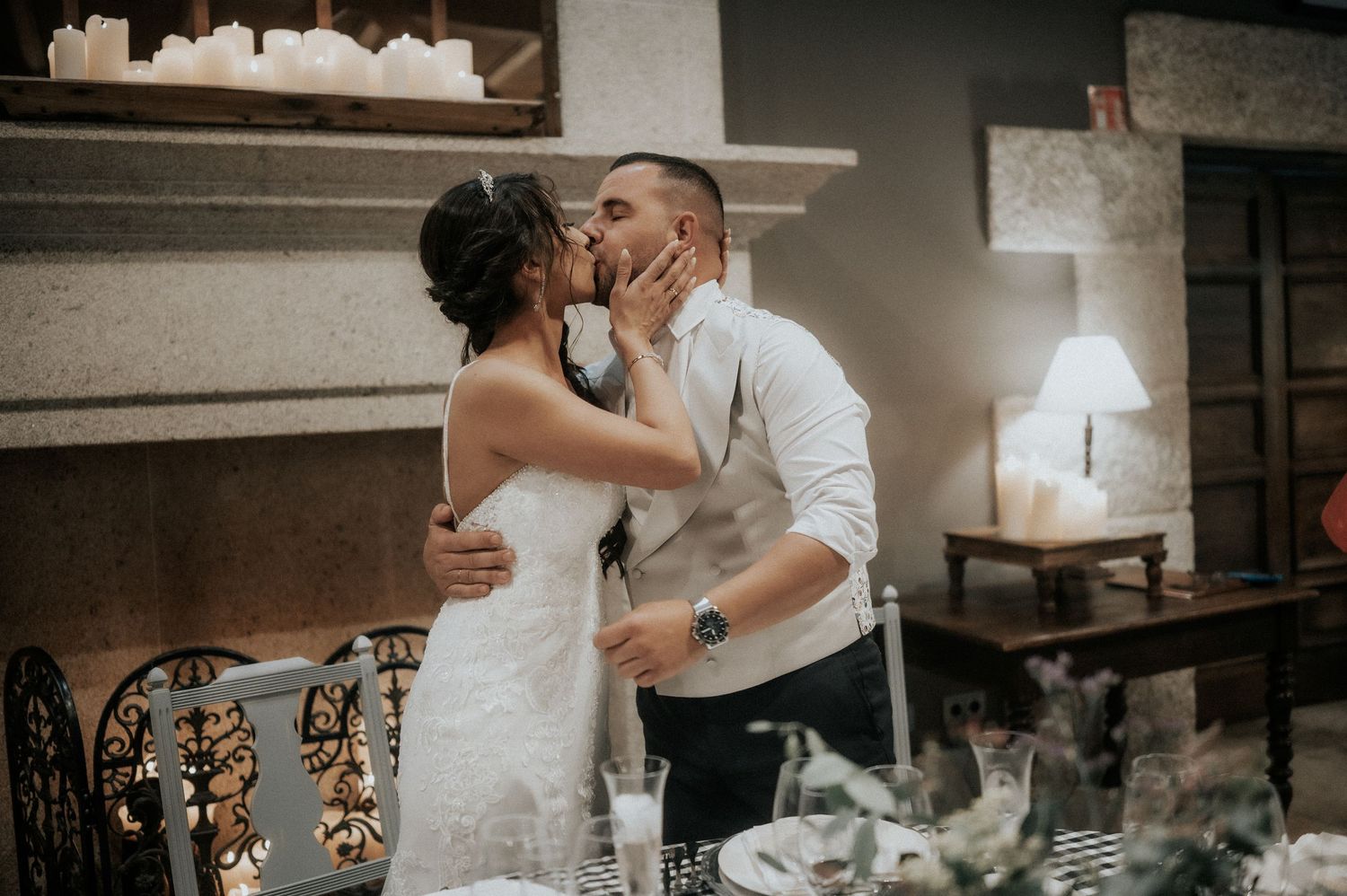 Guests enjoying a lively celebration at an indoor wedding reception with rustic decor.