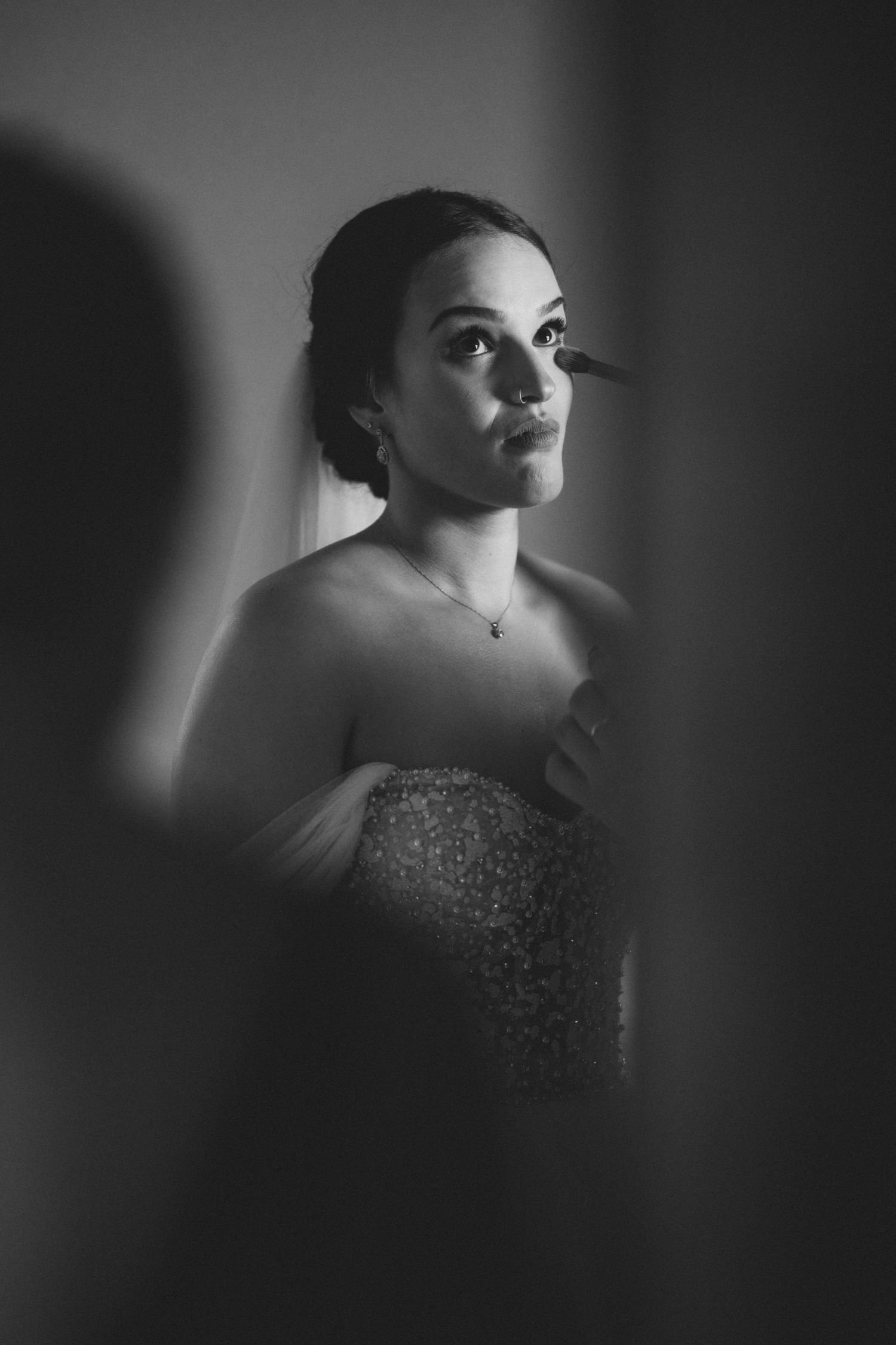 A dramatic black and white portrait series showing a figure in a sequined dress with moody lighting and shadows.