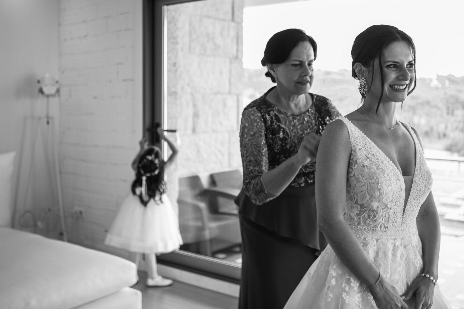 A series of black and white wedding photos showing emotional embraces and tender moments during a celebration.