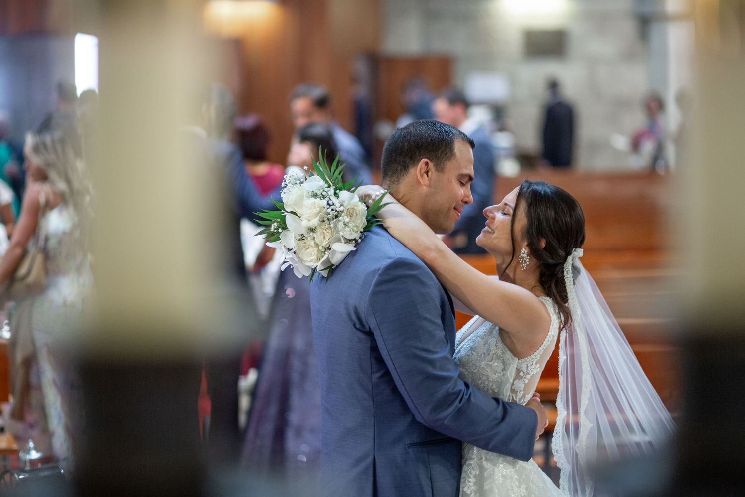 A couple dances together during their wedding celebration indoors.