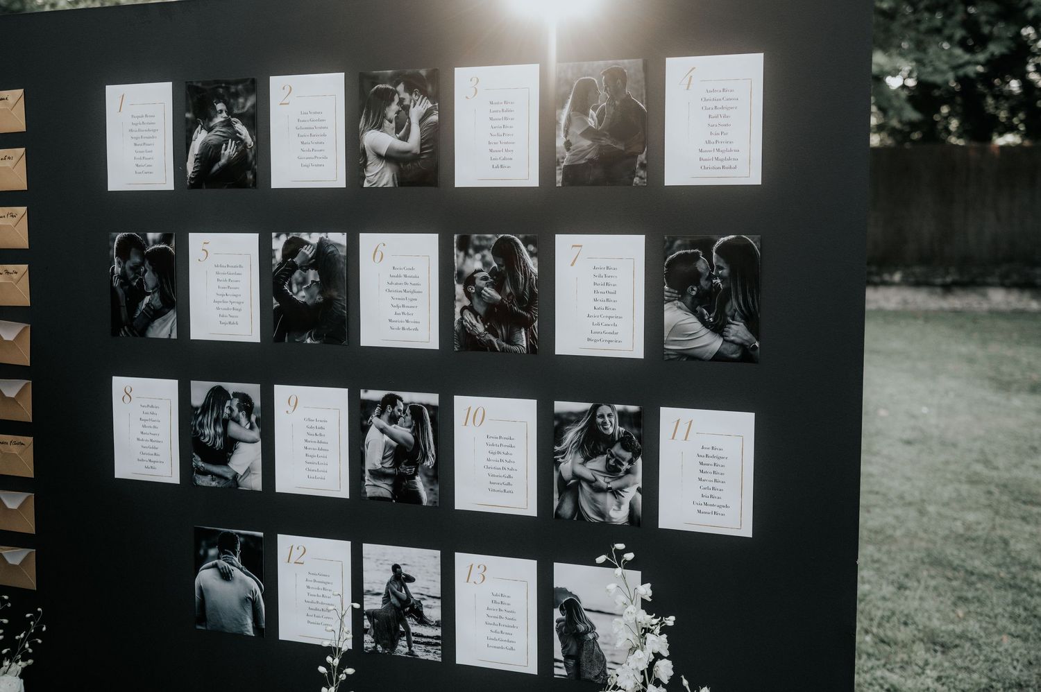 A gallery wall displays black and white photographs with text descriptions mounted on a dark background.