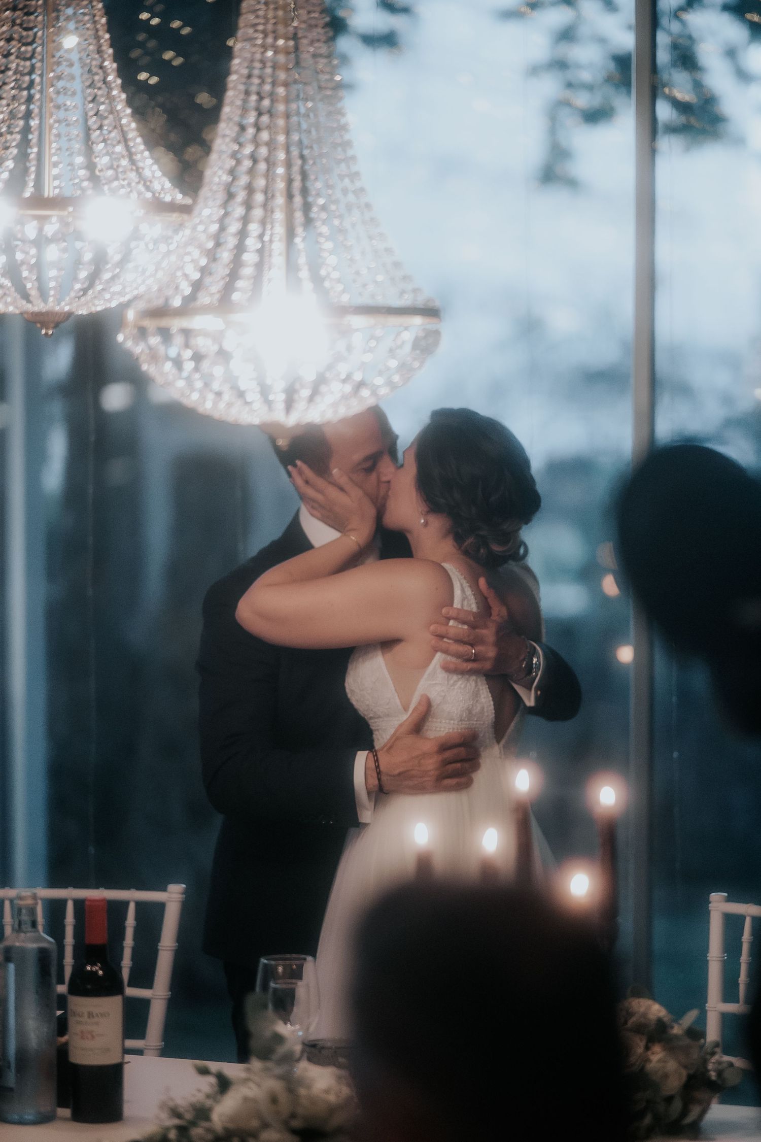 Romantic wedding scene with crystal chandeliers and soft lighting creating an intimate atmosphere.