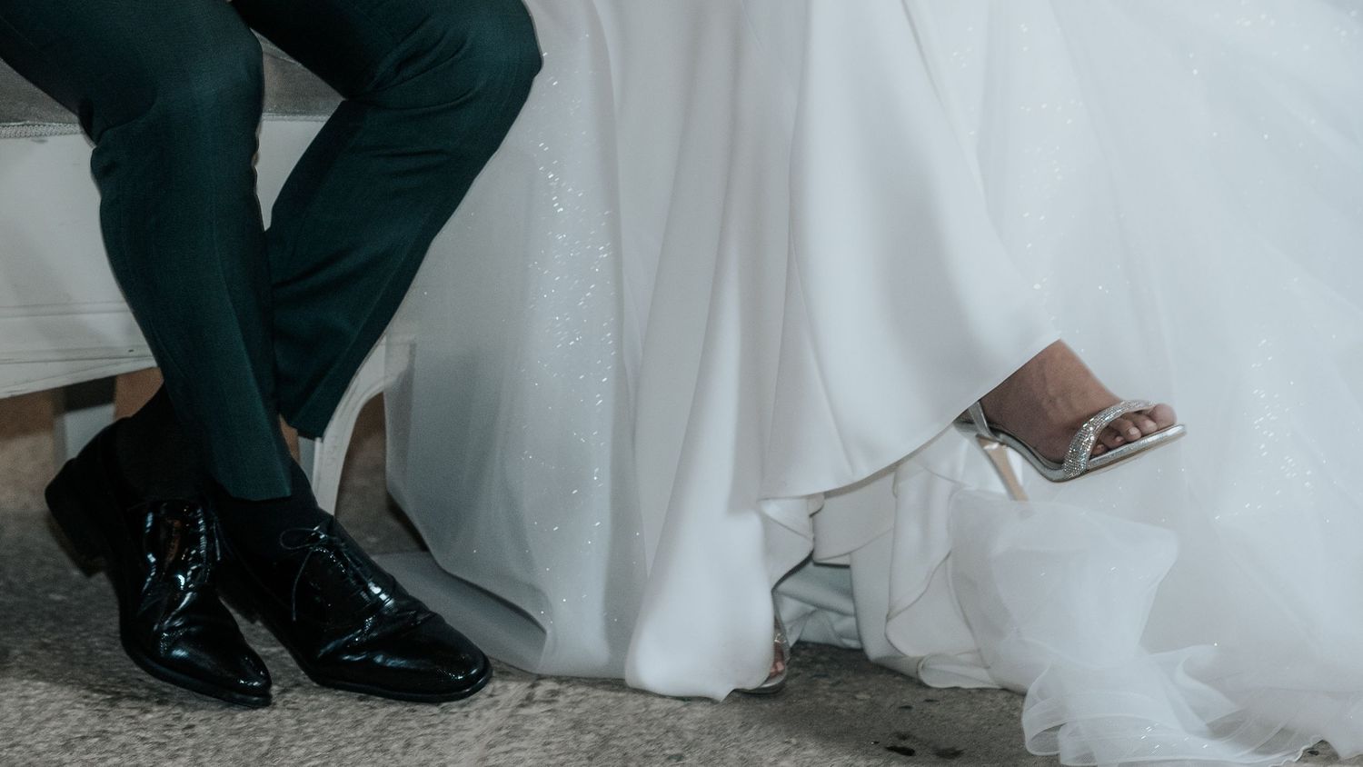 Close-up view of bride and groom's feet during a wedding ceremony.