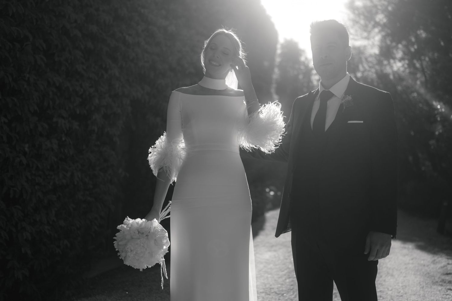 A series of black and white wedding photos showing silhouettes and romantic moments in an outdoor setting.