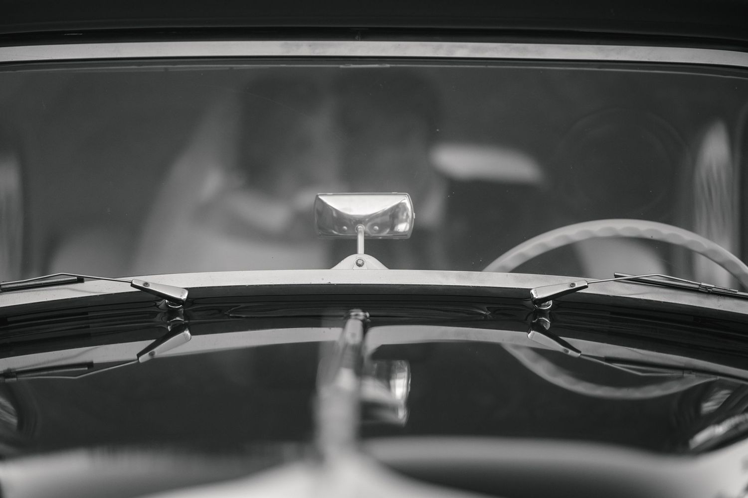A close-up view of a violin's strings, bridge, and polished wooden body in dramatic lighting.