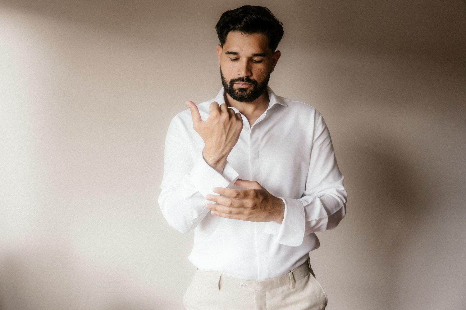 Professional portrait series showing someone in a white button-down shirt against a neutral background in various poses.