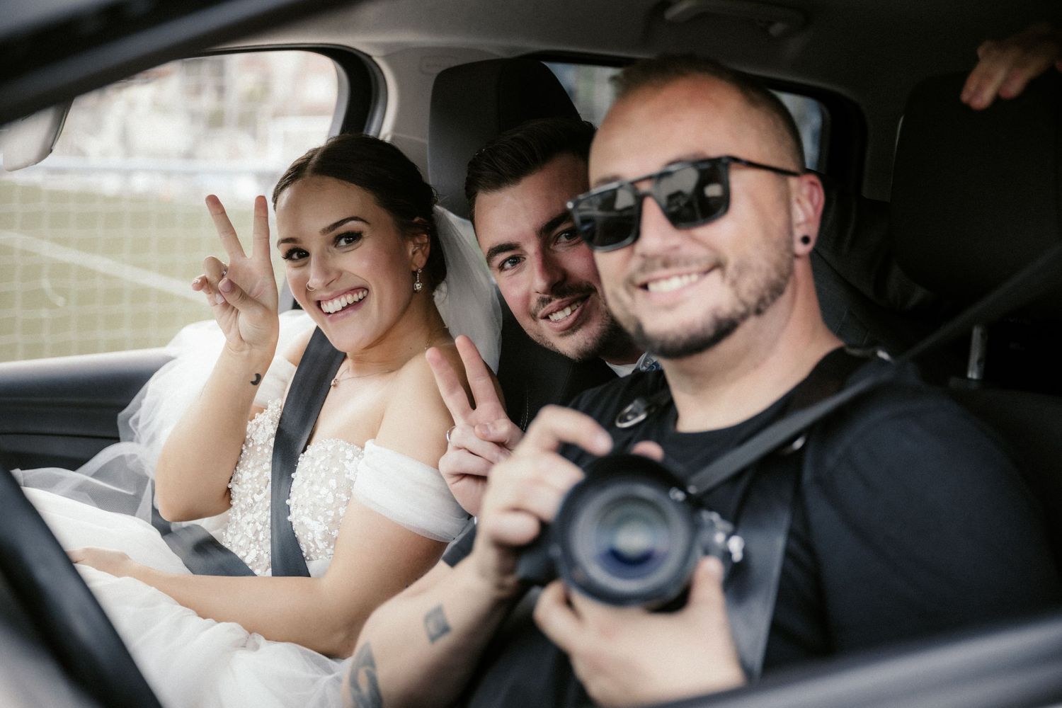 Collage of wedding photos showing couple in car and posing together in black and white style.