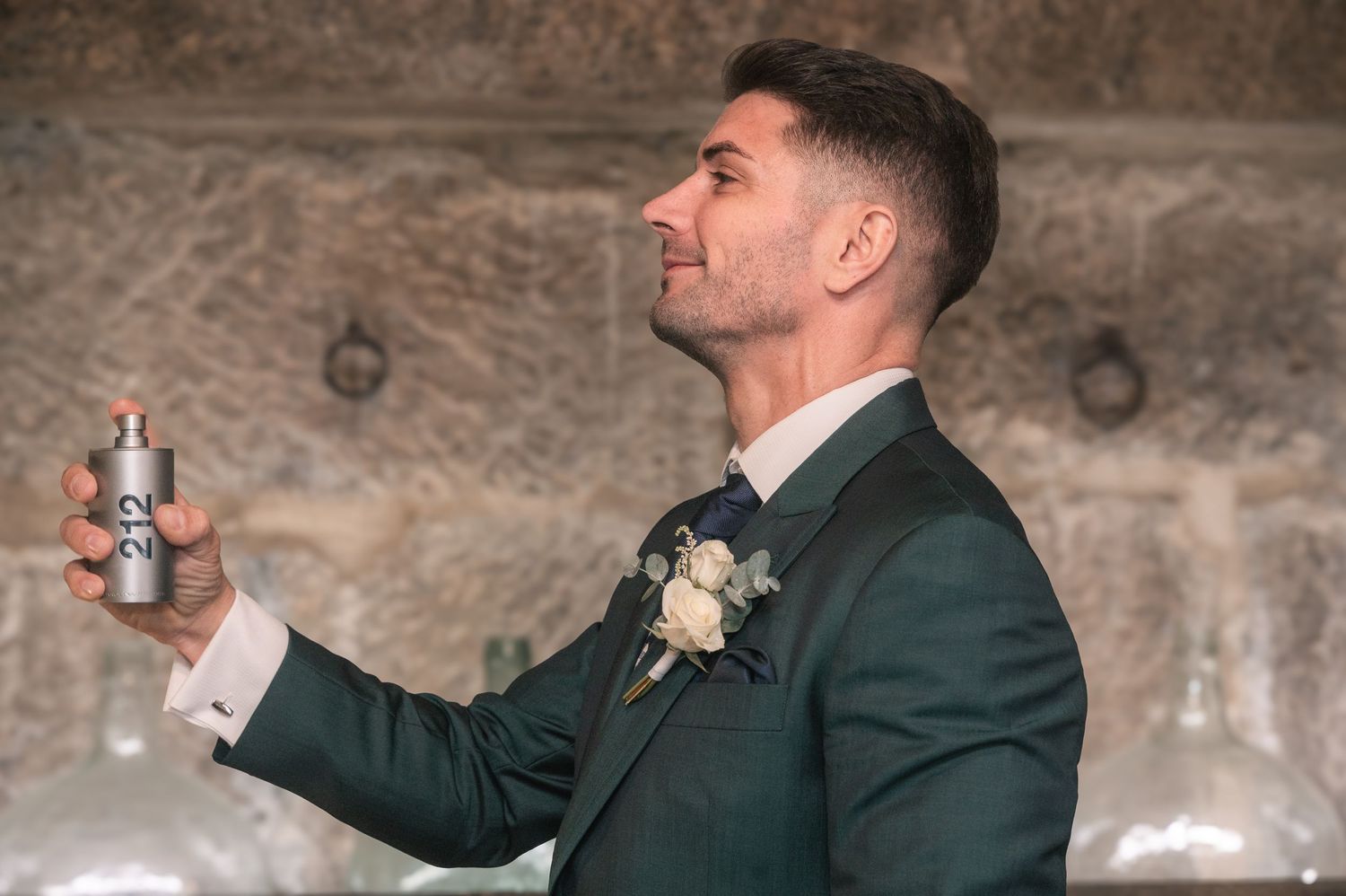 Black and white wedding photography sequence capturing candid moments against stone wall background.