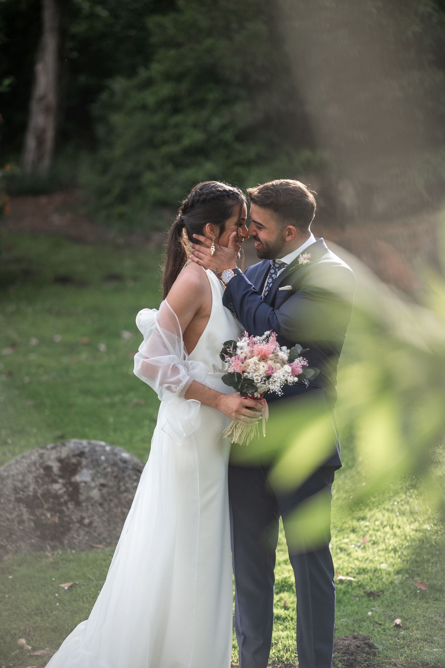 Joyful newlyweds share intimate moments in a lush outdoor garden setting during their wedding photoshoot.