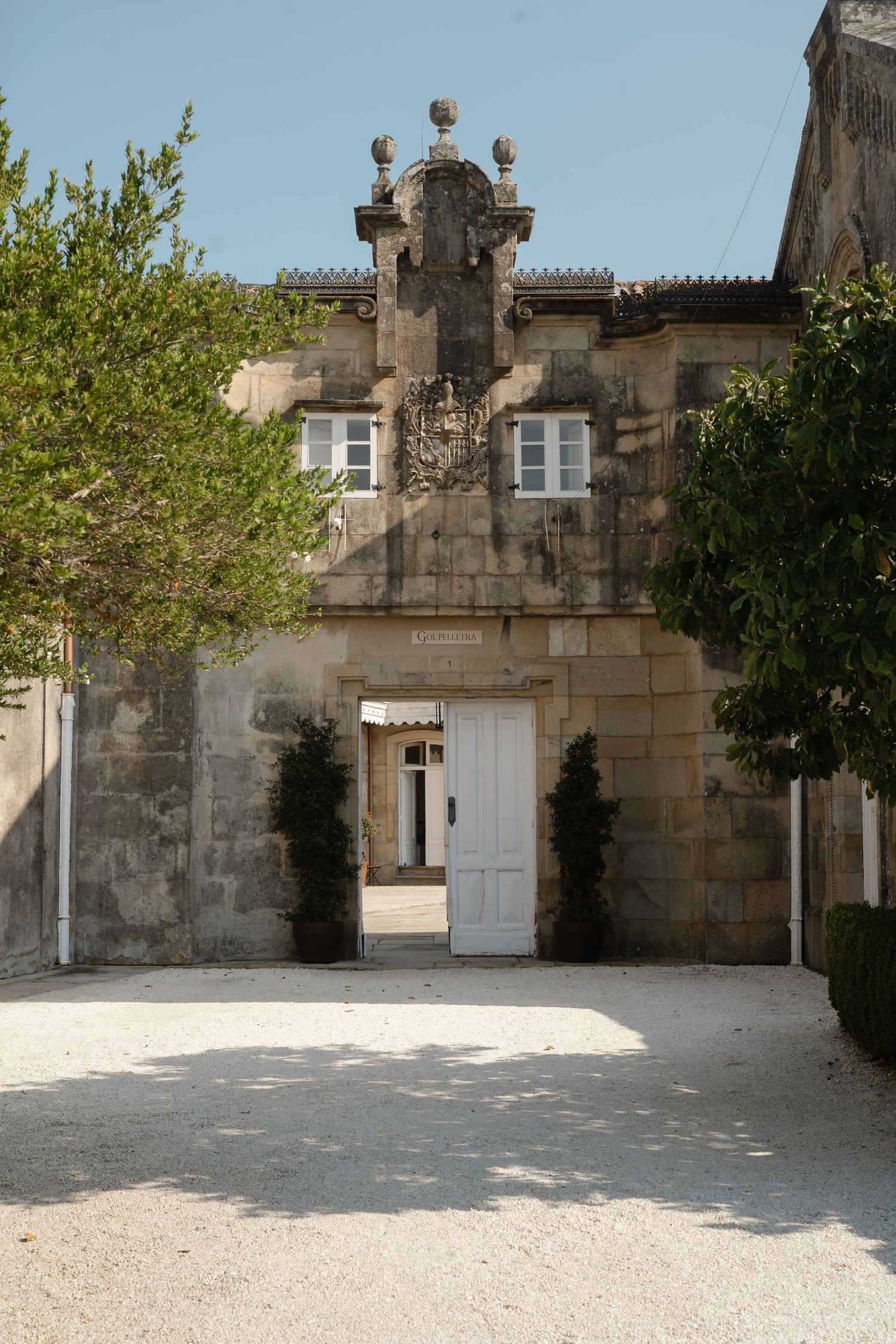 Stone courtyard with white doors and ornate architectural details in a historic European building.