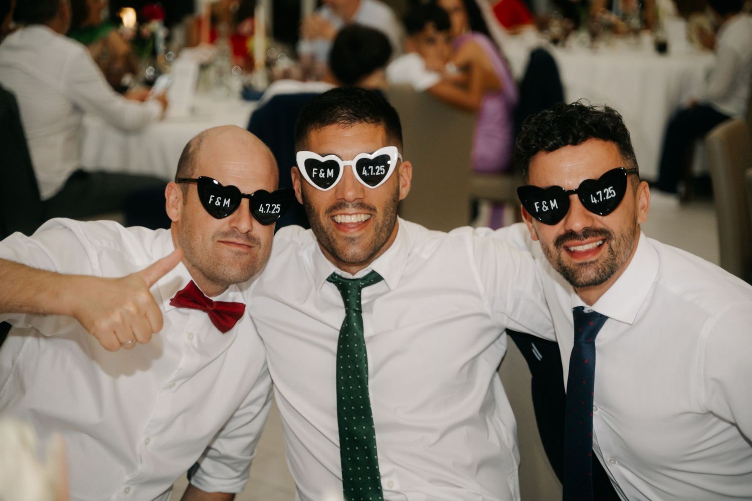Group of people wearing sunglasses and formal attire at a celebration event.