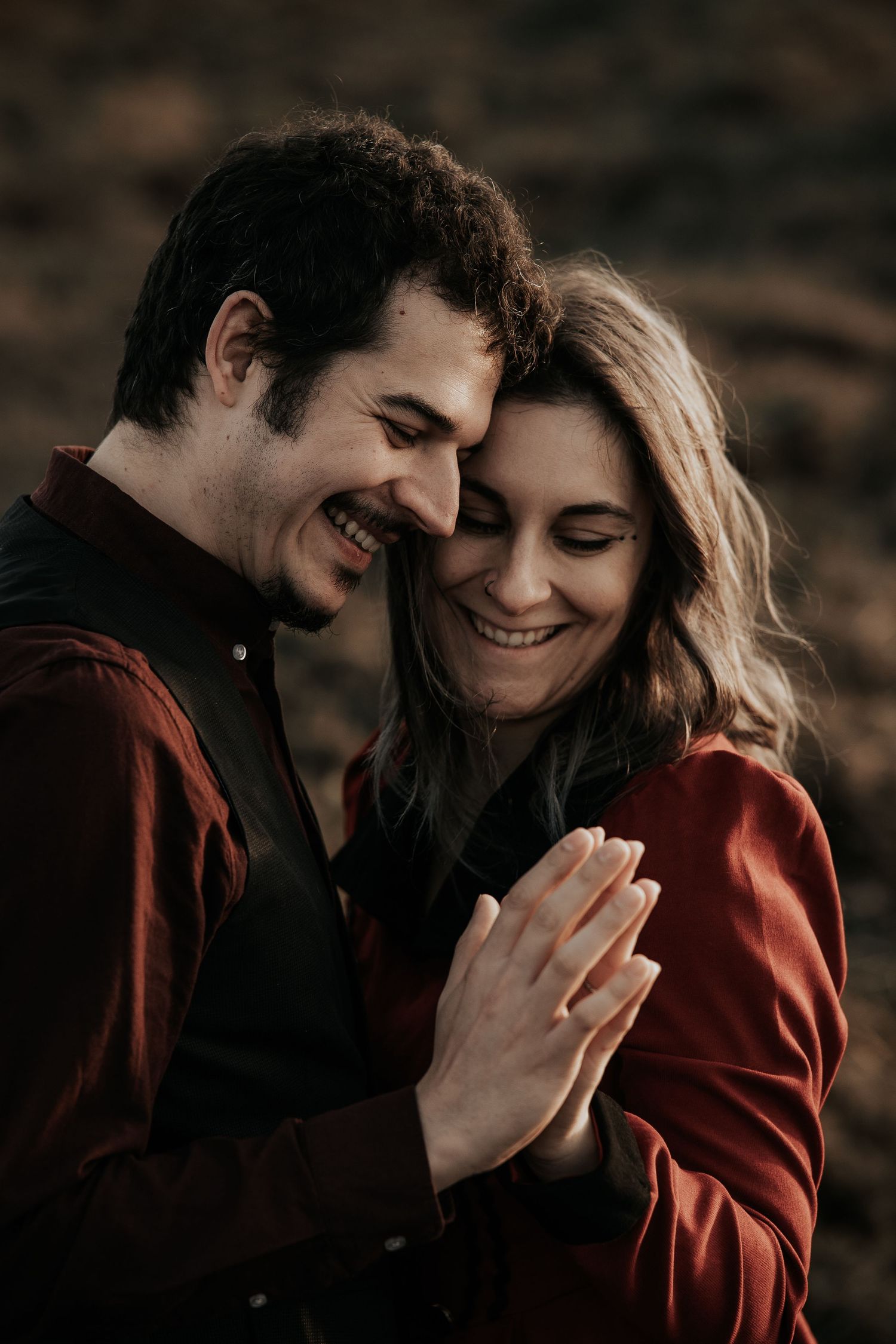A romantic couple shares intimate moments together in a series of candid photos showing them embracing and laughing.