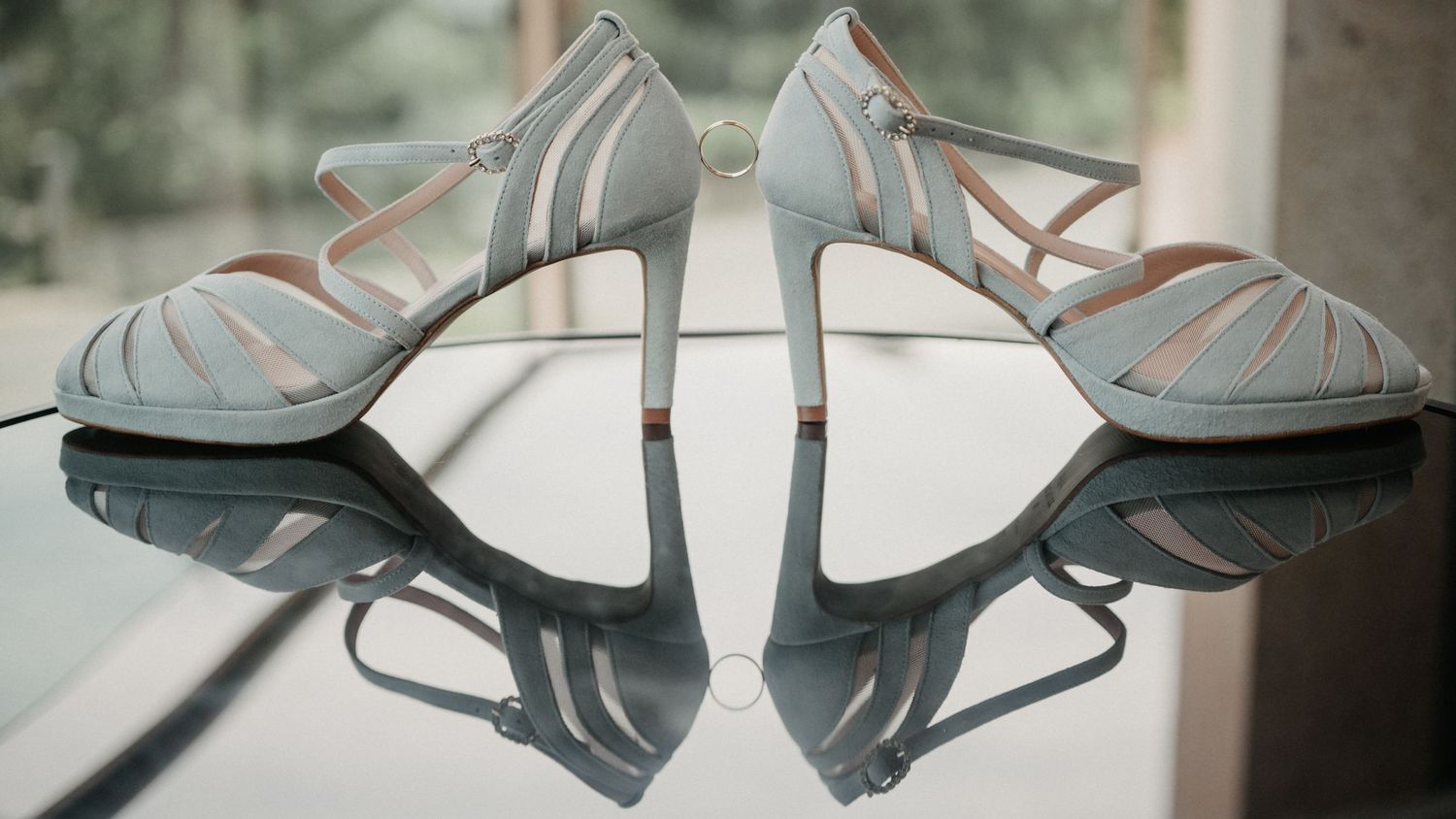 Close-up sequence showing elegant white bridal shoes arranged in different angles against a light background.