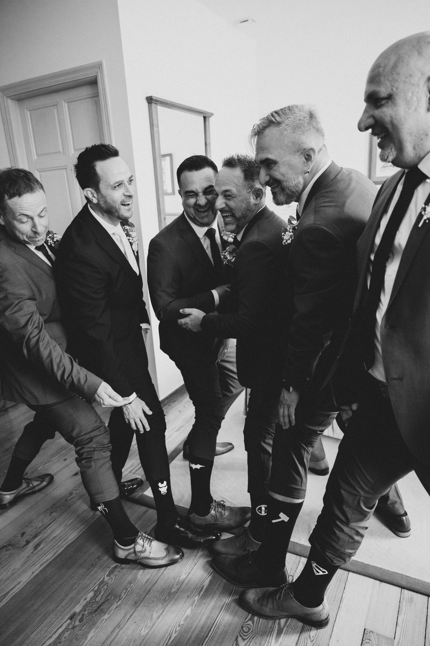 A sequence of black and white photographs showing people bending down to examine something on the floor.