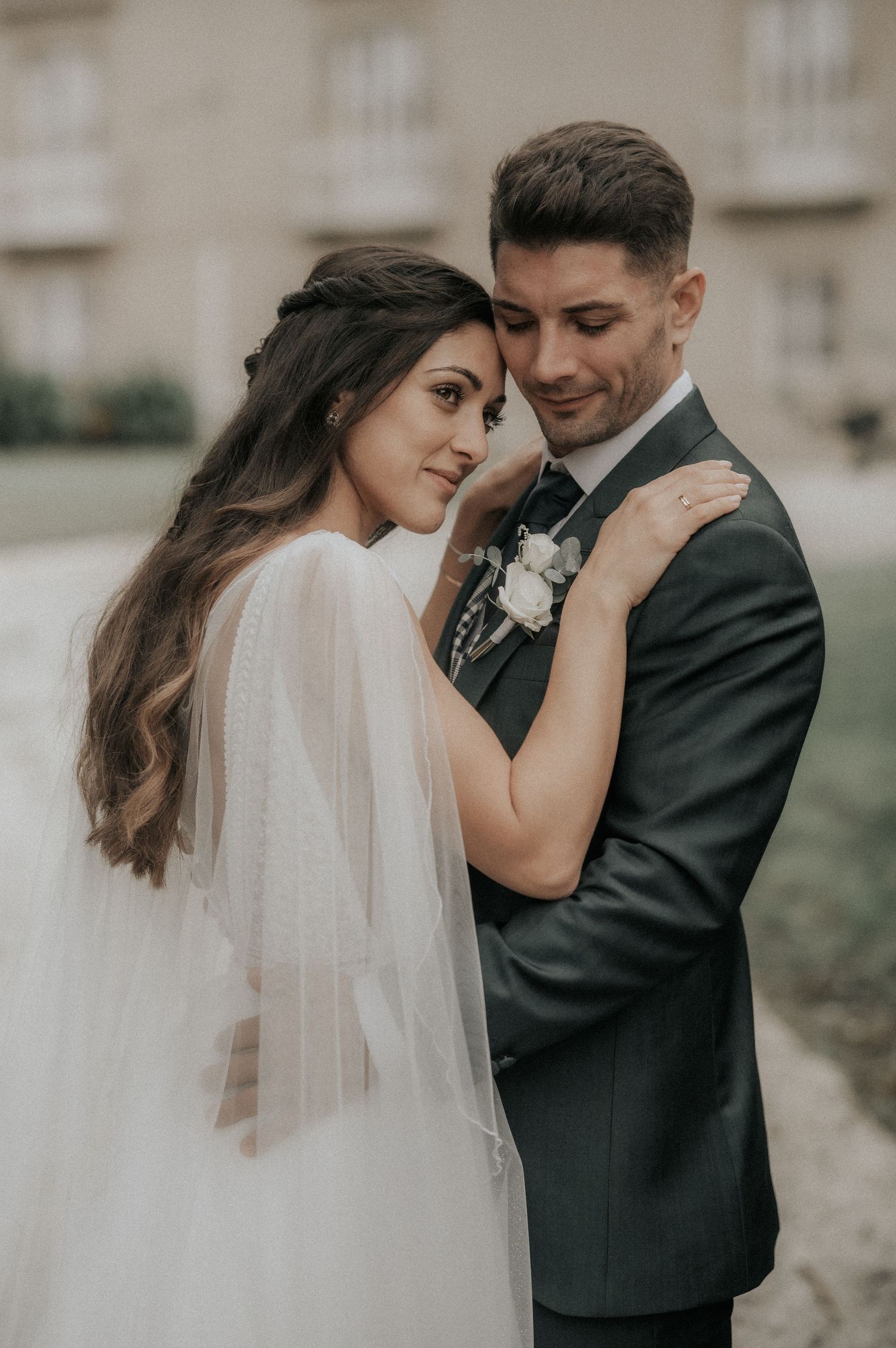 A romantic wedding couple embraces outdoors in a tender moment captured in a series of intimate portraits.