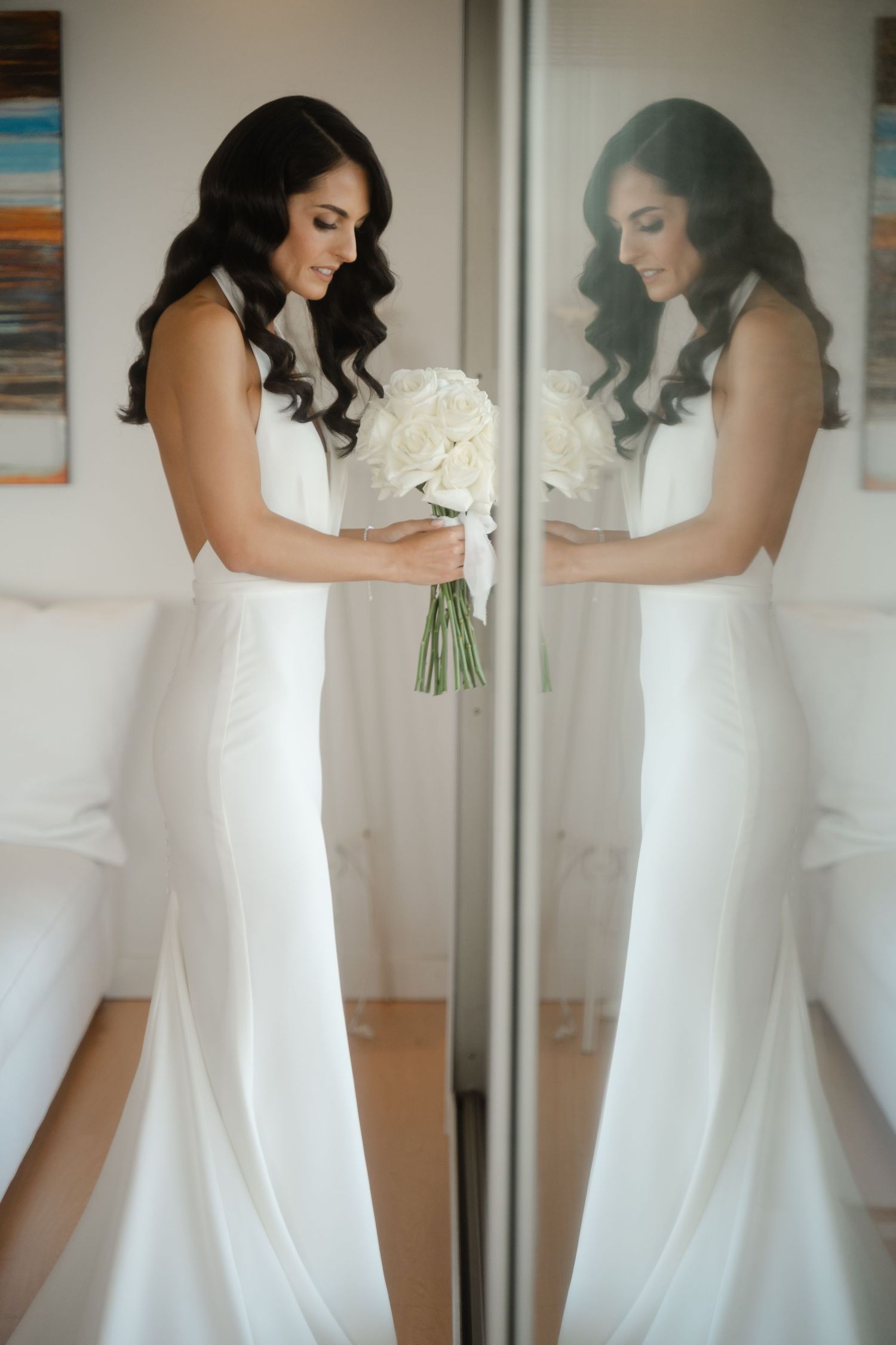 A bride in a flowing white wedding gown is photographed in multiple reflective mirror angles showing elegant movement.