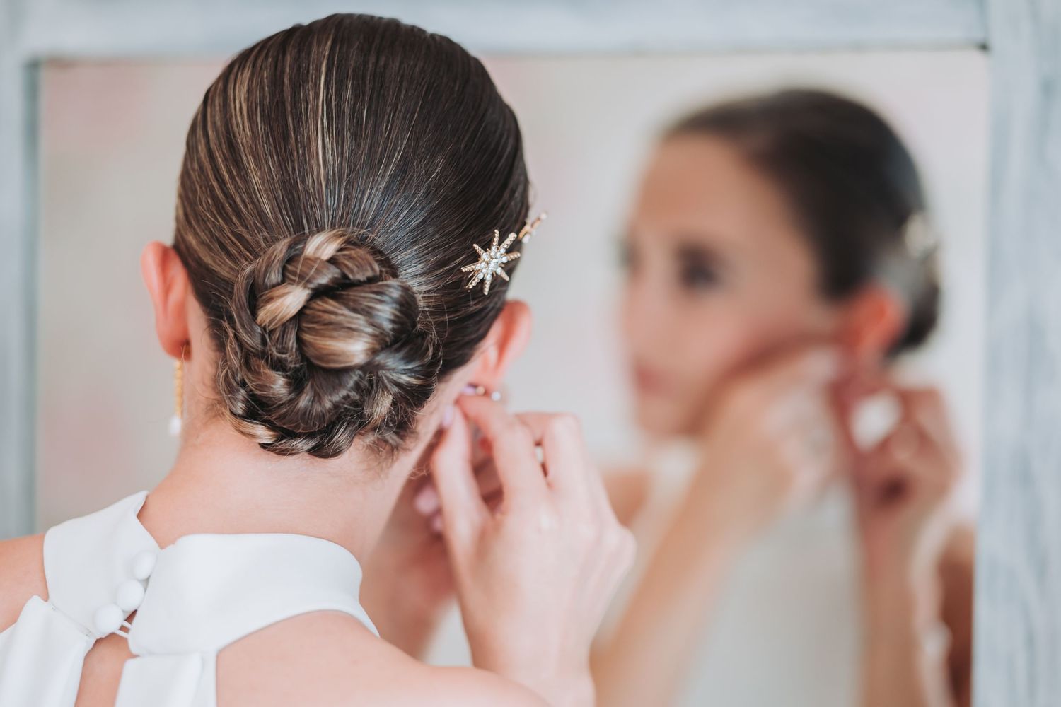 Elegant bridal hairstyles with decorative pins shown from behind.