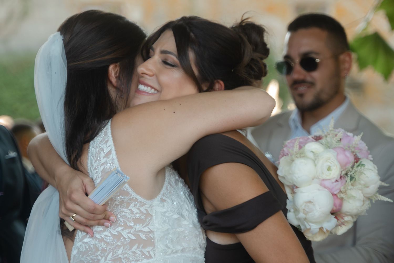 Wedding party sharing embraces and celebrations after the ceremony.